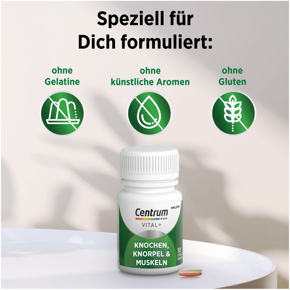 Flacon blanc Centrum Vital+ avec comprimé. Texte : Sans gélatine, arômes artificiels, gluten.