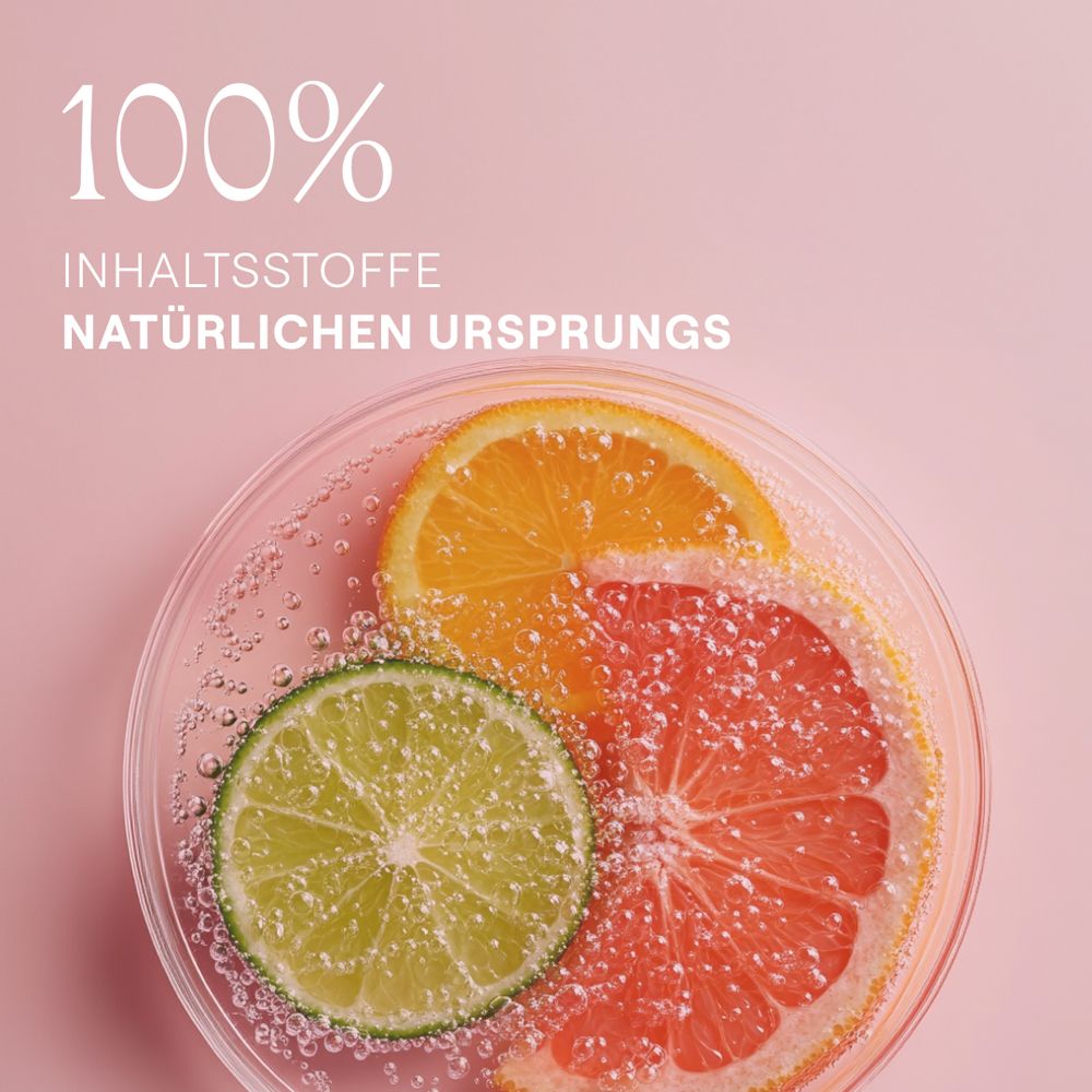 Zitrusfrüchte in einer Glasschale. 100% Inhaltsstoffe natürlichen Ursprungs. Rosa Hintergrund.