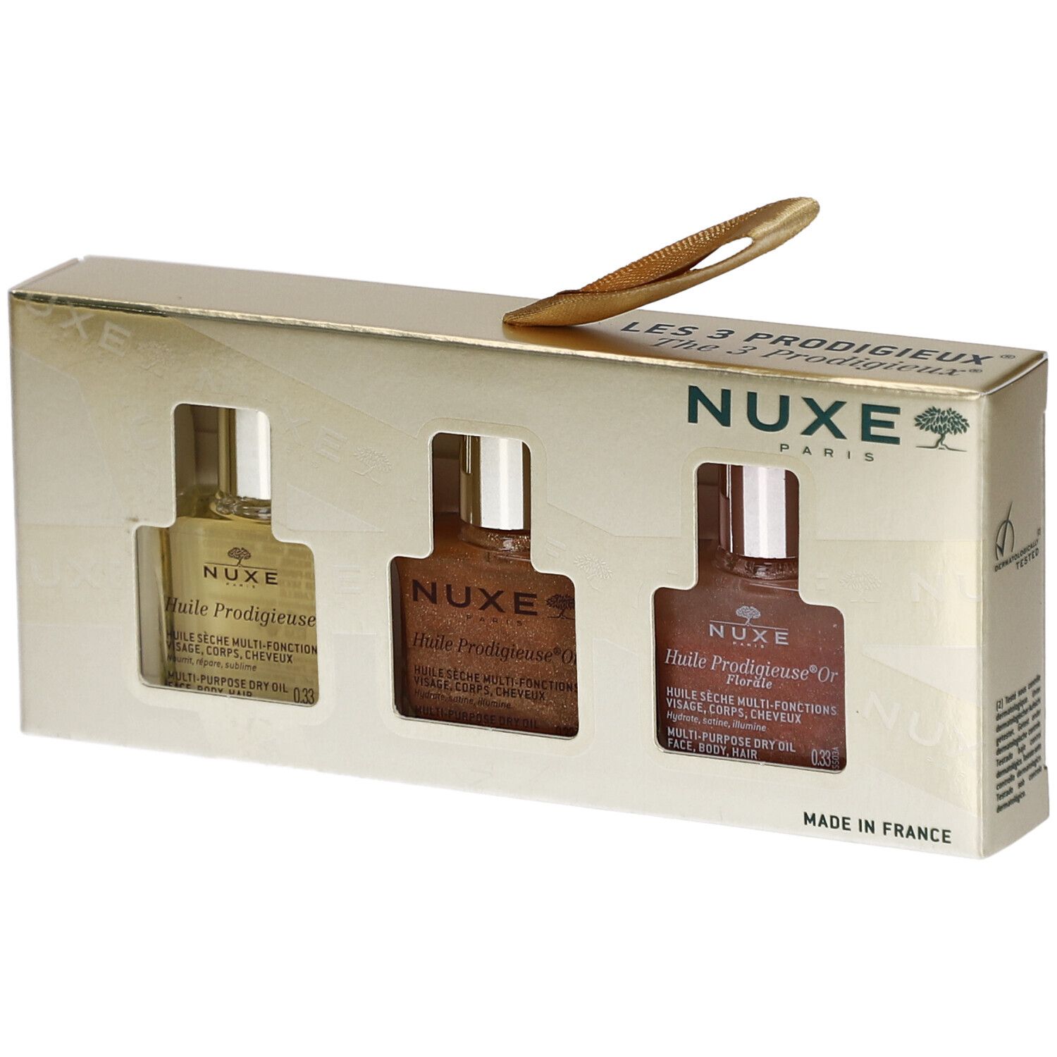 Geschenkset mit drei Flaschen Öl. Goldfarbene Verpackung mit Sichtfenstern. NUXE-Logo und Produktnamen sichtbar.