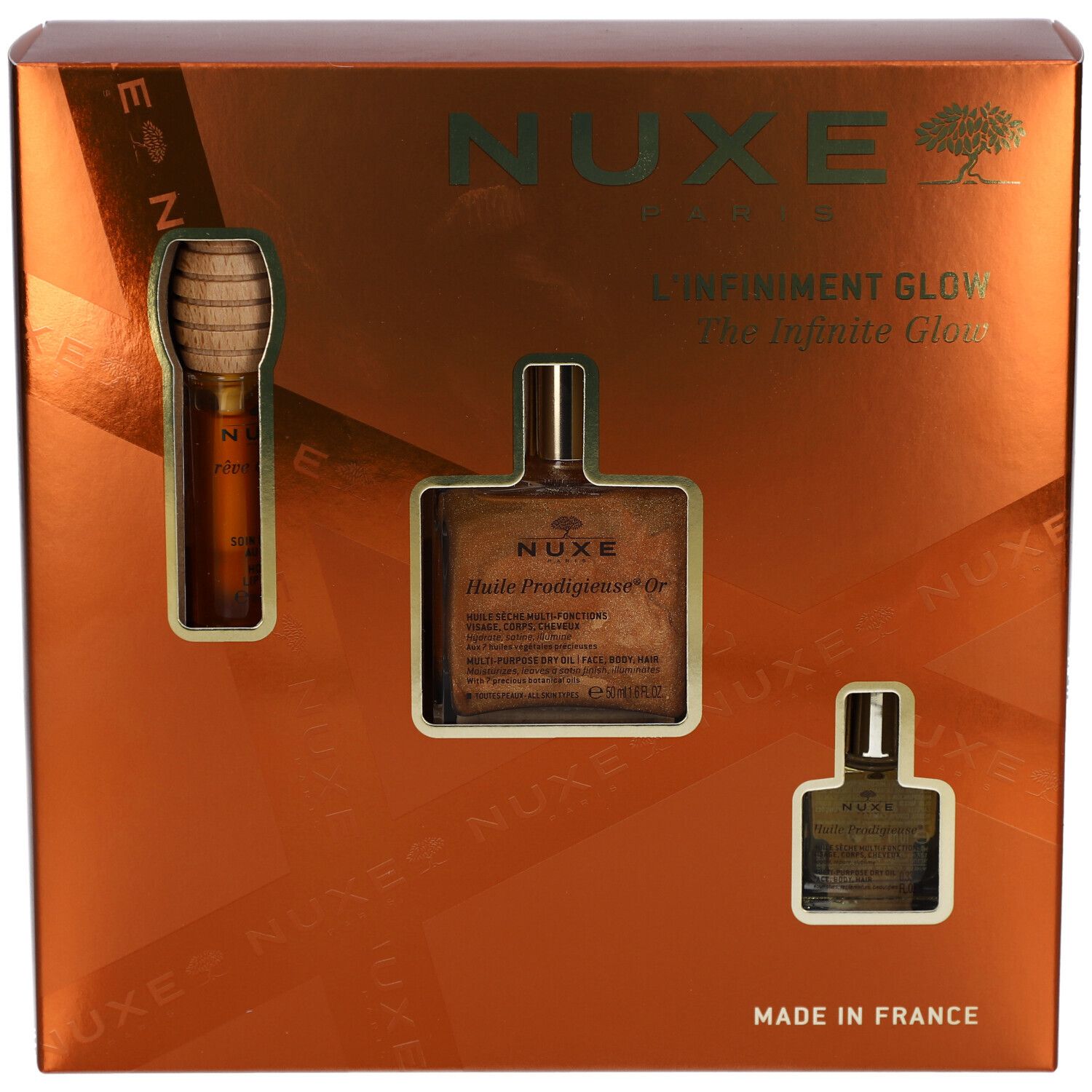 Coffret cadeau avec trois produits. Logo NUXE, inscription "L'Infiniment Glow". Emballage doré.