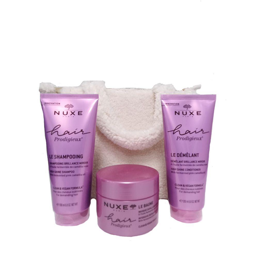 Ensemble de trois produits capillaires et un sac crème. Tubes et pot violets, avec texte. NUXE Hair Prodigieux.