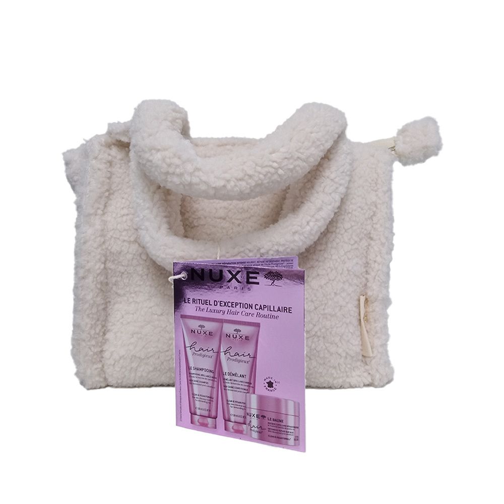 Sac crème avec anses et étiquette. L'étiquette montre une image de produits capillaires. NUXE Hair Prodigieux.