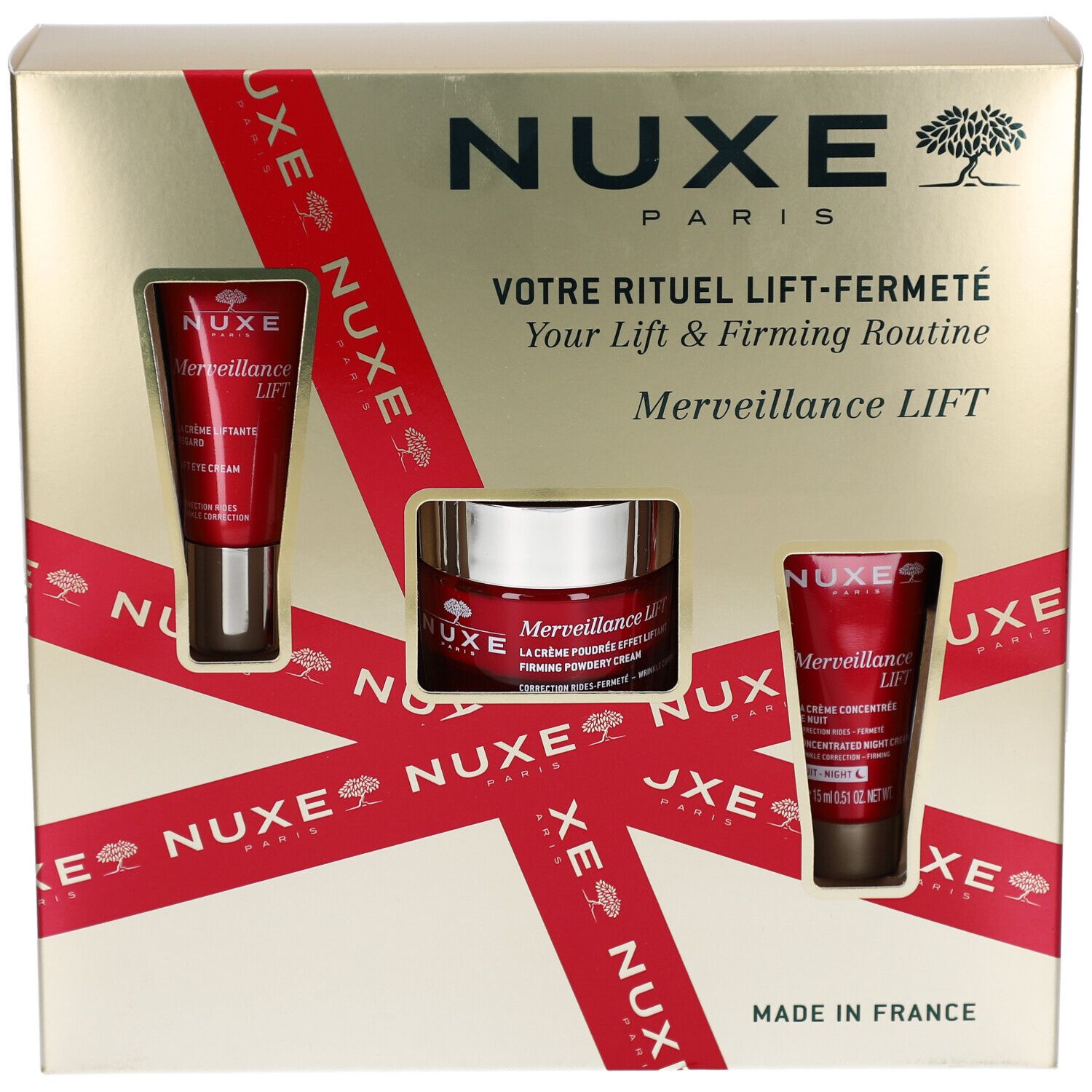 Geschenkbox mit drei Kosmetikprodukten. Goldfarbene Box mit roter Schleife und Produktfenstern. NUXE-Logo und Schriftzug.