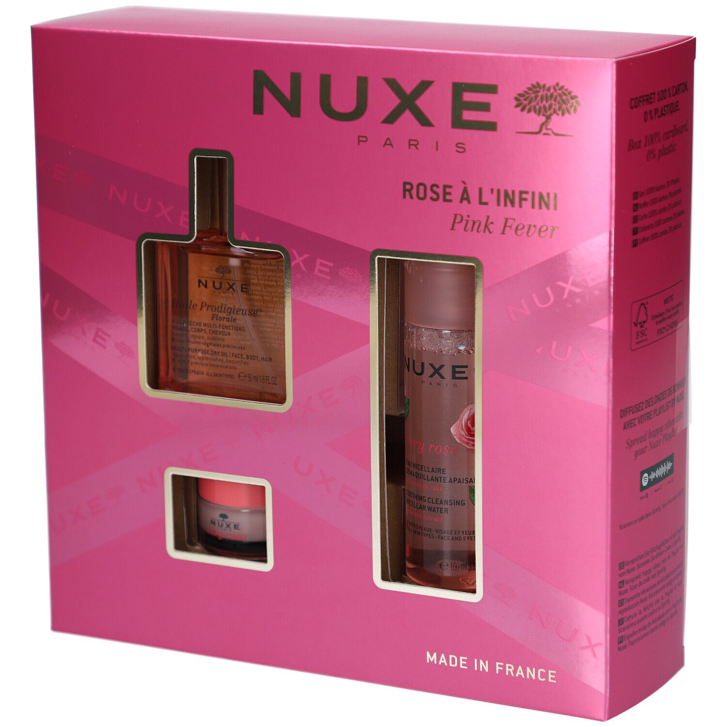 Rosa Geschenkset mit drei Produkten in einer pinken Schachtel. Sichtbar: Flasche, Tiegel und Sprayflasche. NUXE-Logo.
