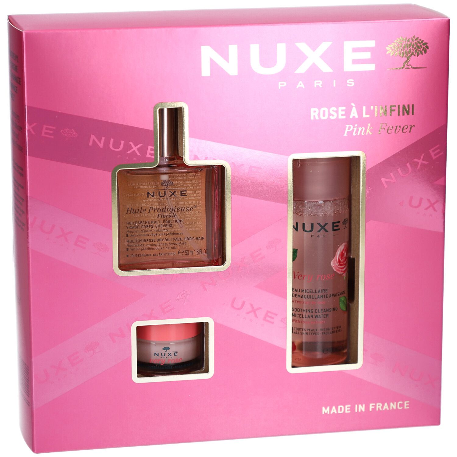 Rosa Geschenkset mit drei Produkten in einer pinken Schachtel. Sichtbar: Flasche, Tiegel und Sprayflasche. NUXE-Logo.