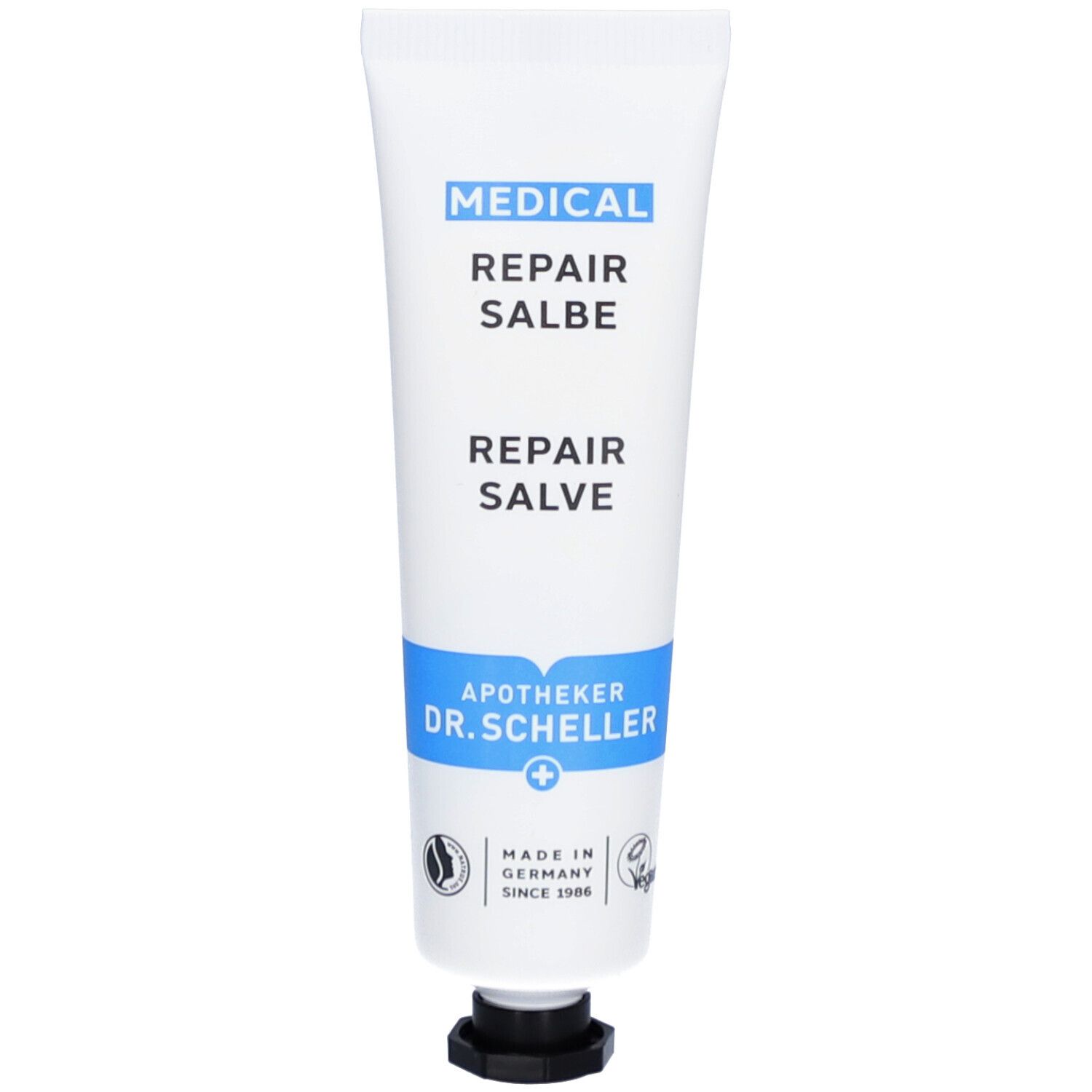 Weiße Tube mit blauer Markierung. Aufschrift: MEDICAL REPAIR SALBE. Apotheker Dr. Scheller. Vegan.