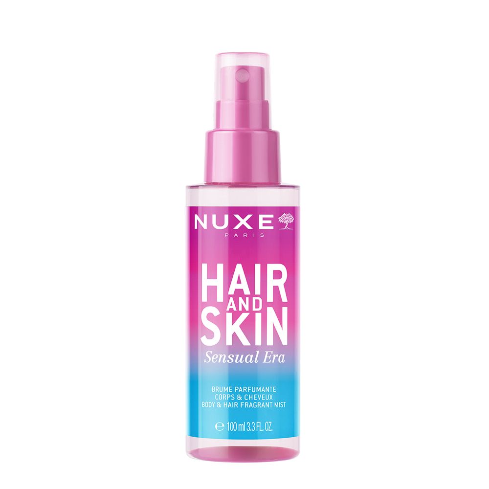 NUXE® Hair and Skin Sensual Era Duftspray. Rosa-farbene Flasche mit Sprühkopf. Text: Hair and Skin, Sensual Era.