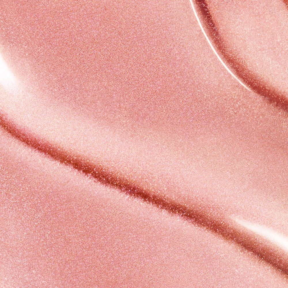 Gros plan sur un liquide rose et scintillant. Texture brillante.