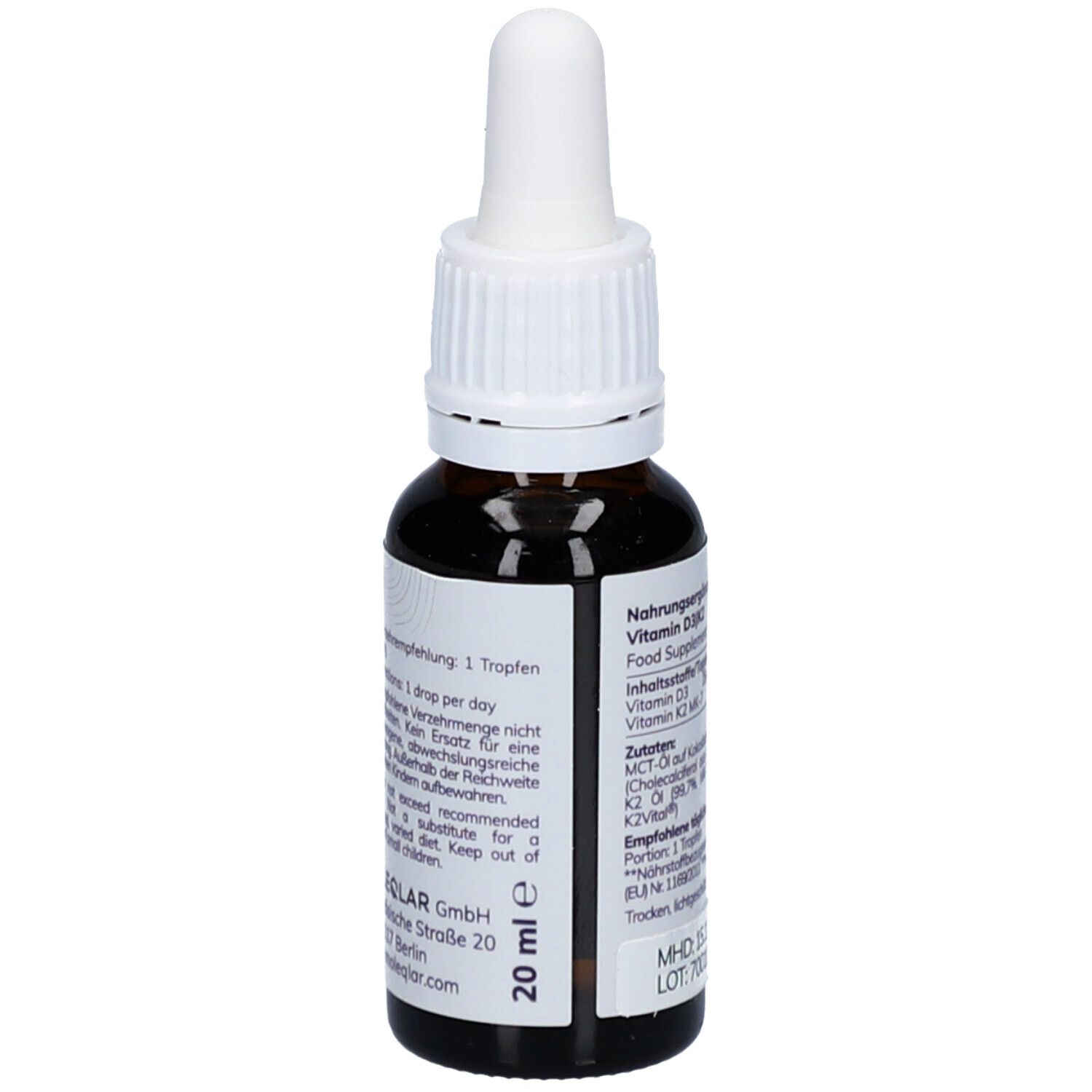Dos d'un flacon en verre brun avec bouchon blanc. Inscription: Complément alimentaire. Ingrédients: Vitamine D3, K2. 20 ml.