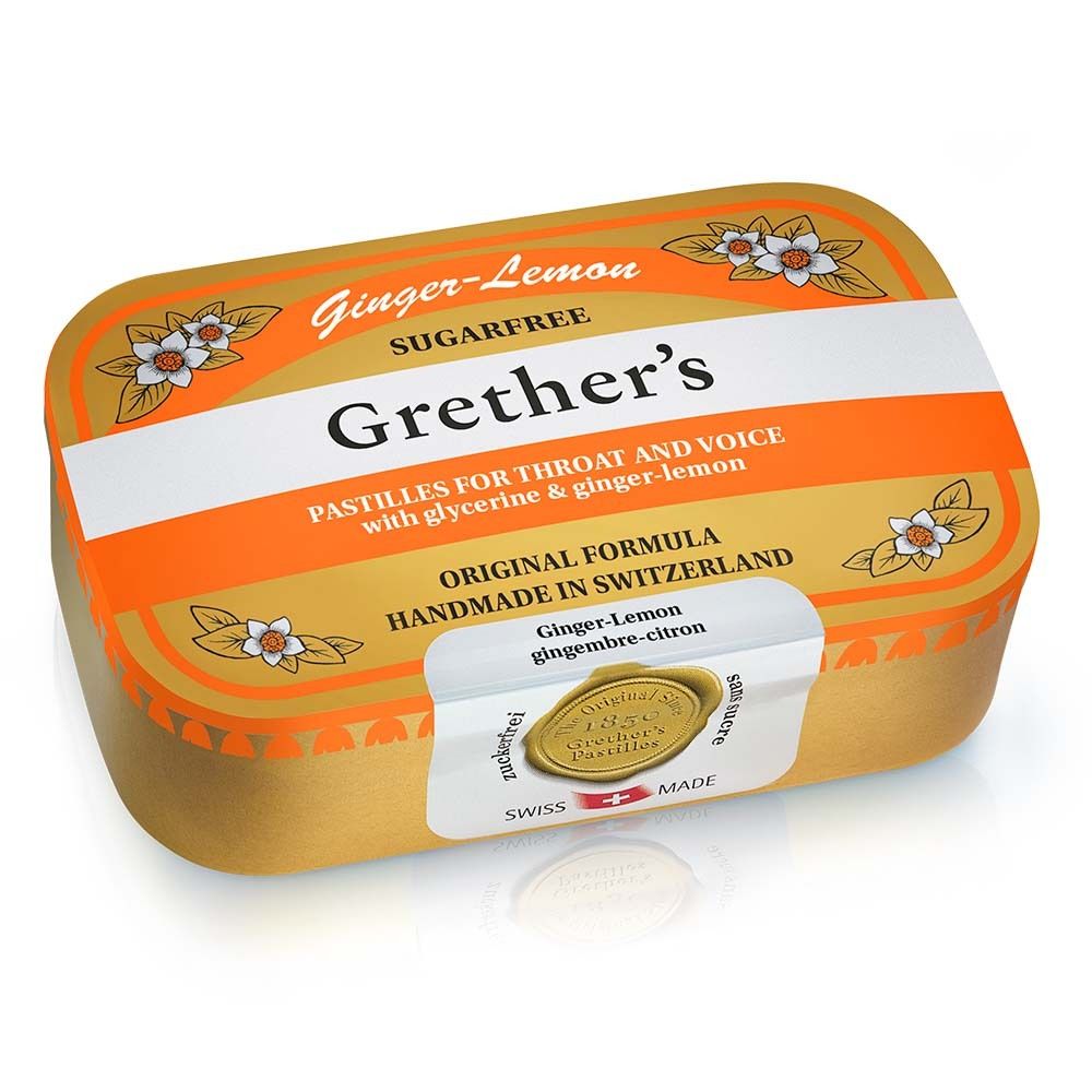Boîte dorée de Grether's Pastilles Ginger Lemon. Bande blanche avec nom du produit. Décor floral. Label de qualité suisse.
