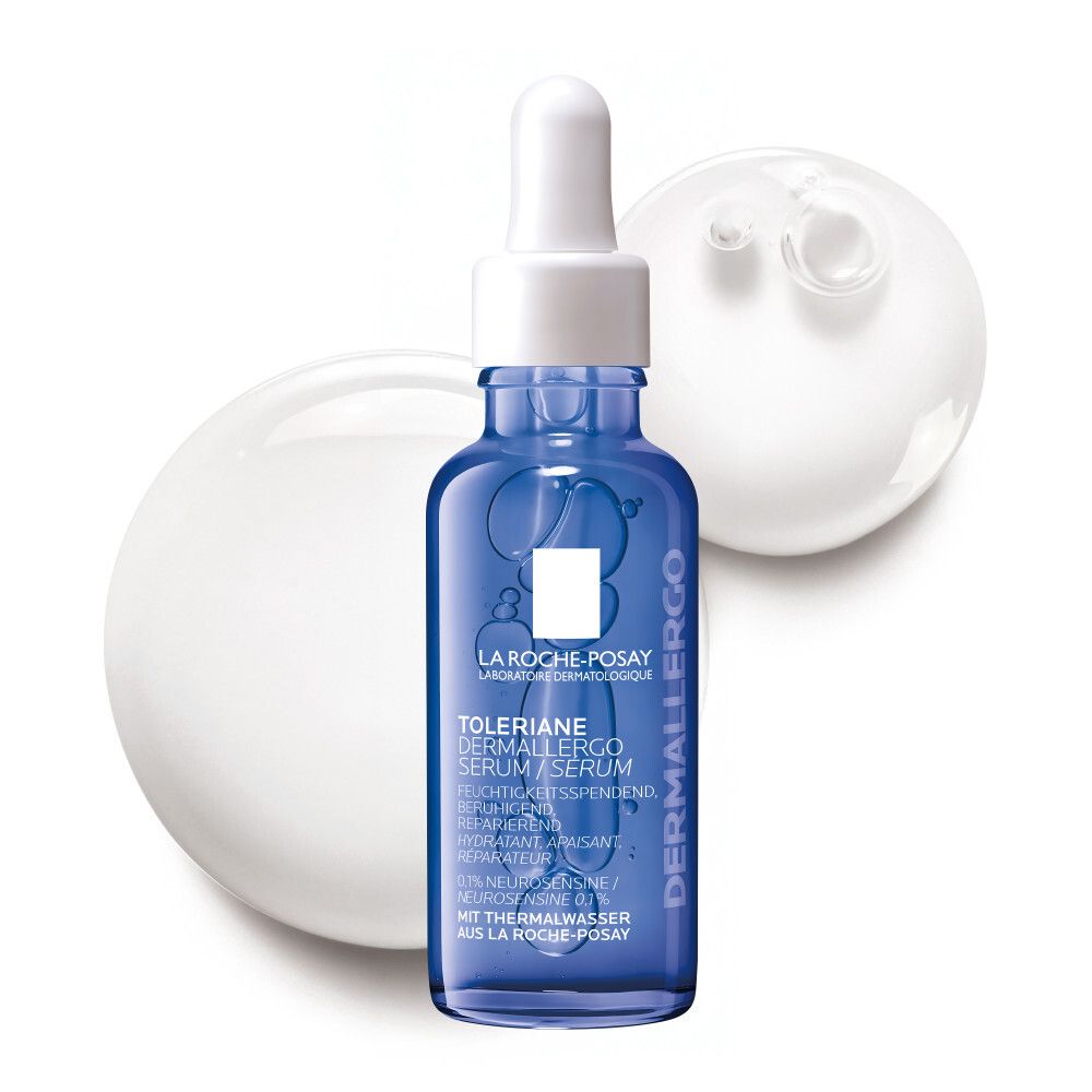 Flacon de sérum bleu avec pipette. Inscription : Toleriane Dermallergo Serum. Logo La Roche-Posay. Gouttes blanches en arrière-plan.
