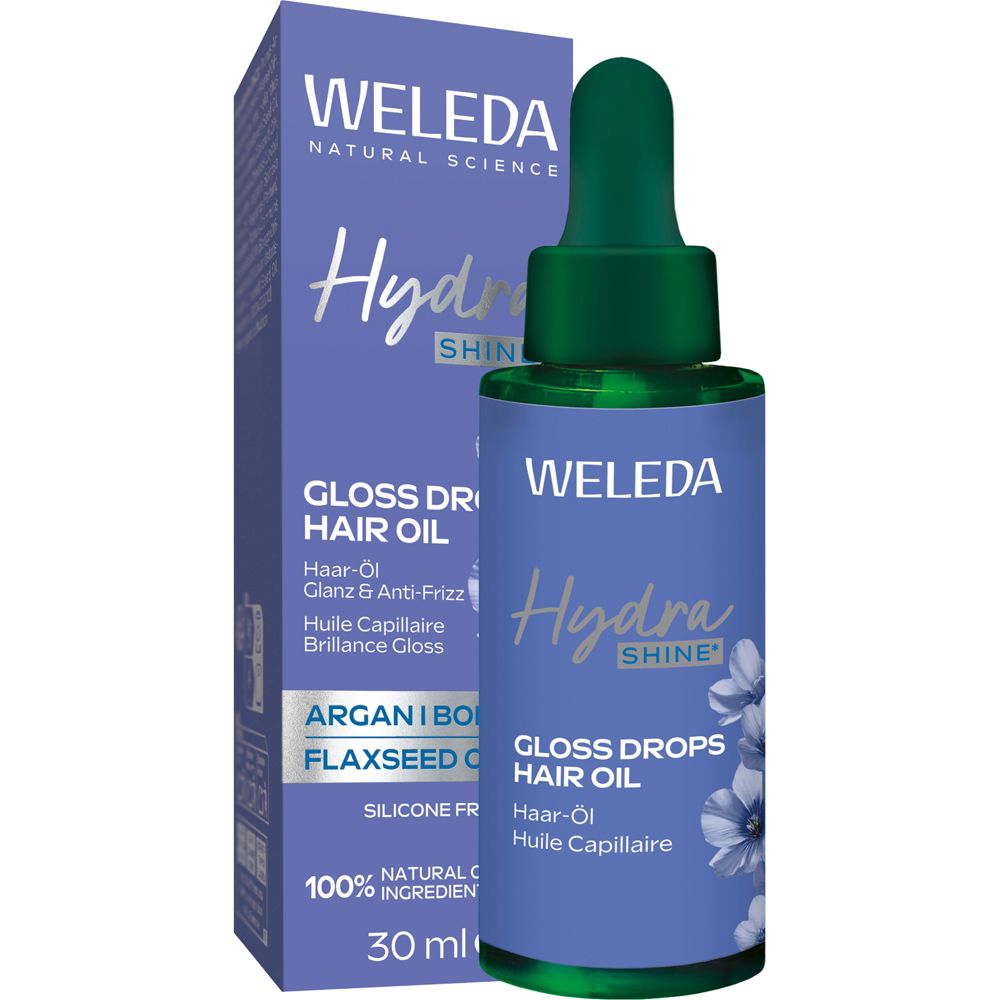 Weleda Hydra Shine Gloss Drops Haar-Öl. Flasche und Verpackung. Lila-weiß Design. Produktname und Marke sichtbar.