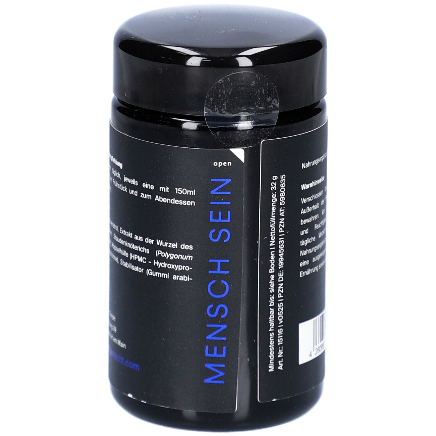 Boîte noire avec étiquette bleue. Inscription : MENSCH SEIN. Informations sur les ingrédients et la durée de conservation minimale.