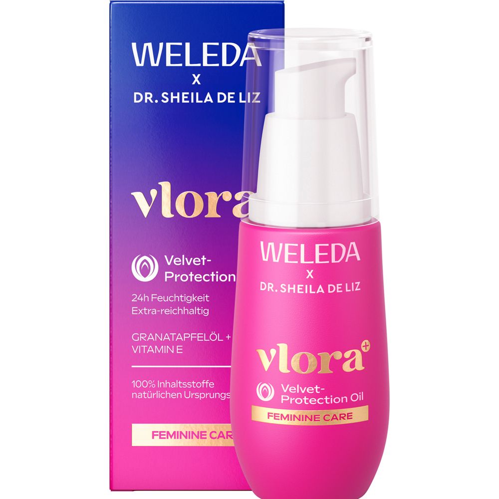 Weleda Vlora+ Velvet Protection Oil. Flacon rose avec pompe et boîte. Marque et nom du produit visibles.