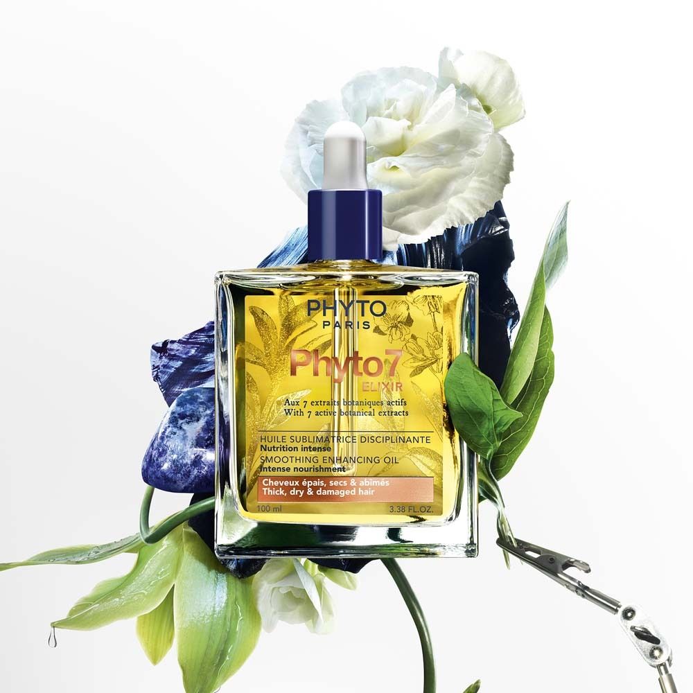 Flacon d'huile avec pipette, entouré de fleurs et de feuilles. Inscription: PHYTO PARIS, Phyto 7 Elixir. Pour cheveux épais, secs et abîmés.