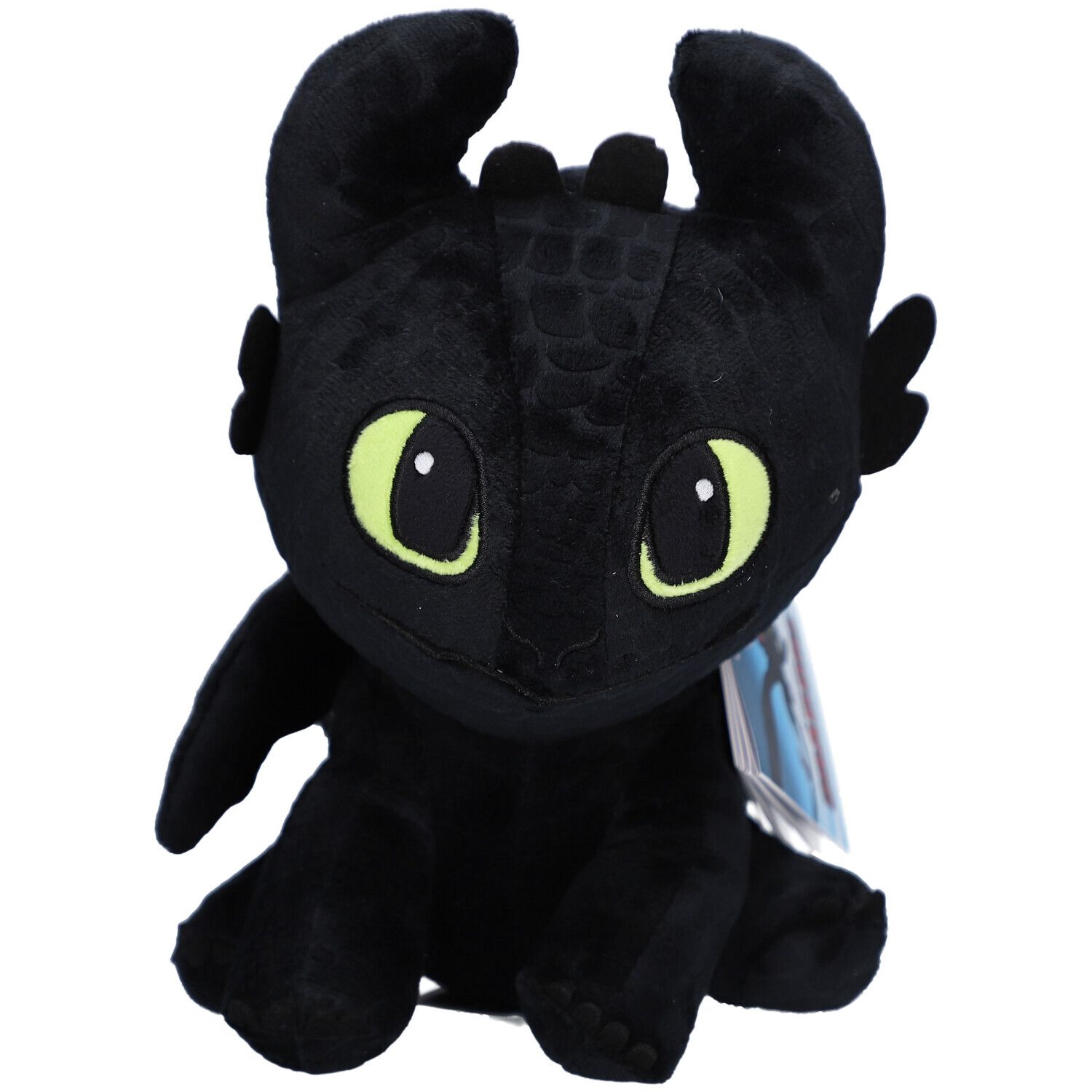 Peluche noire en forme de dragon, yeux verts, oreilles, ailes. Sur fond clair.