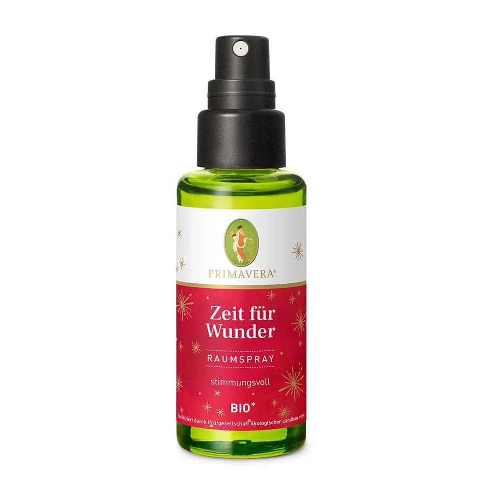 Grüne Glasflasche mit schwarzem Sprühkopf. Etikett mit rotem Hintergrund, Sternen und dem Text "Zeit für Wunder".