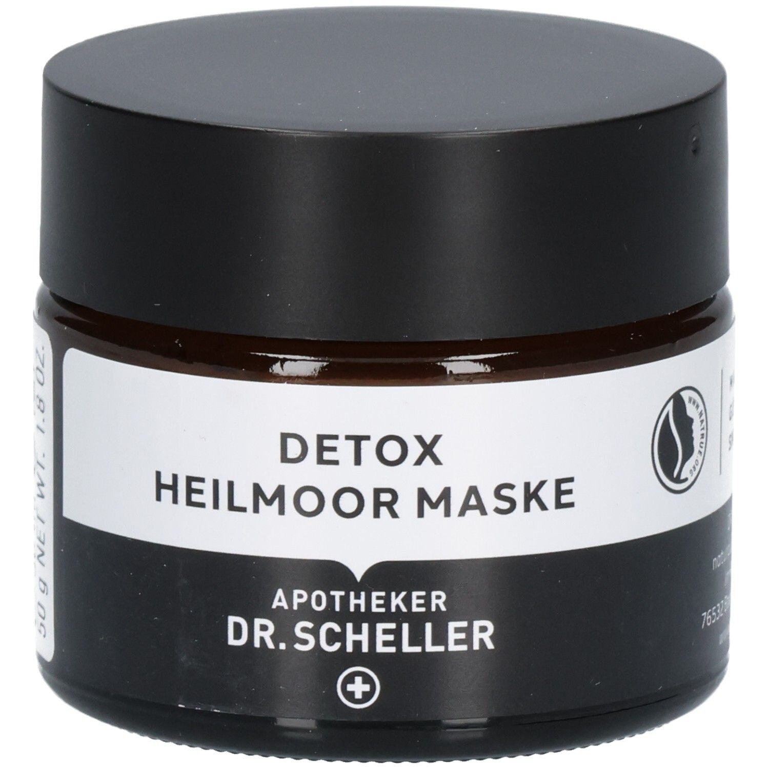 Dunkles Glasgefäß mit schwarzem Deckel, Etikett mit "DETOX HEILMOOR MASKE" und "DR. SCHELLER".