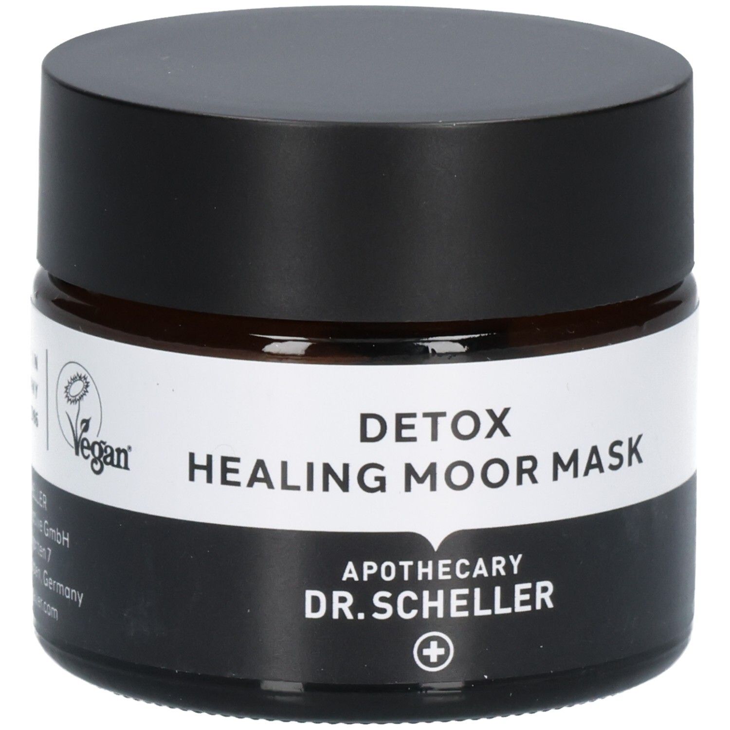 Dunkles Glasgefäß mit schwarzem Deckel, Etikett mit "VEGAN"-Siegel, "DETOX HEALING MOOR MASK" und "DR. SCHELLER".