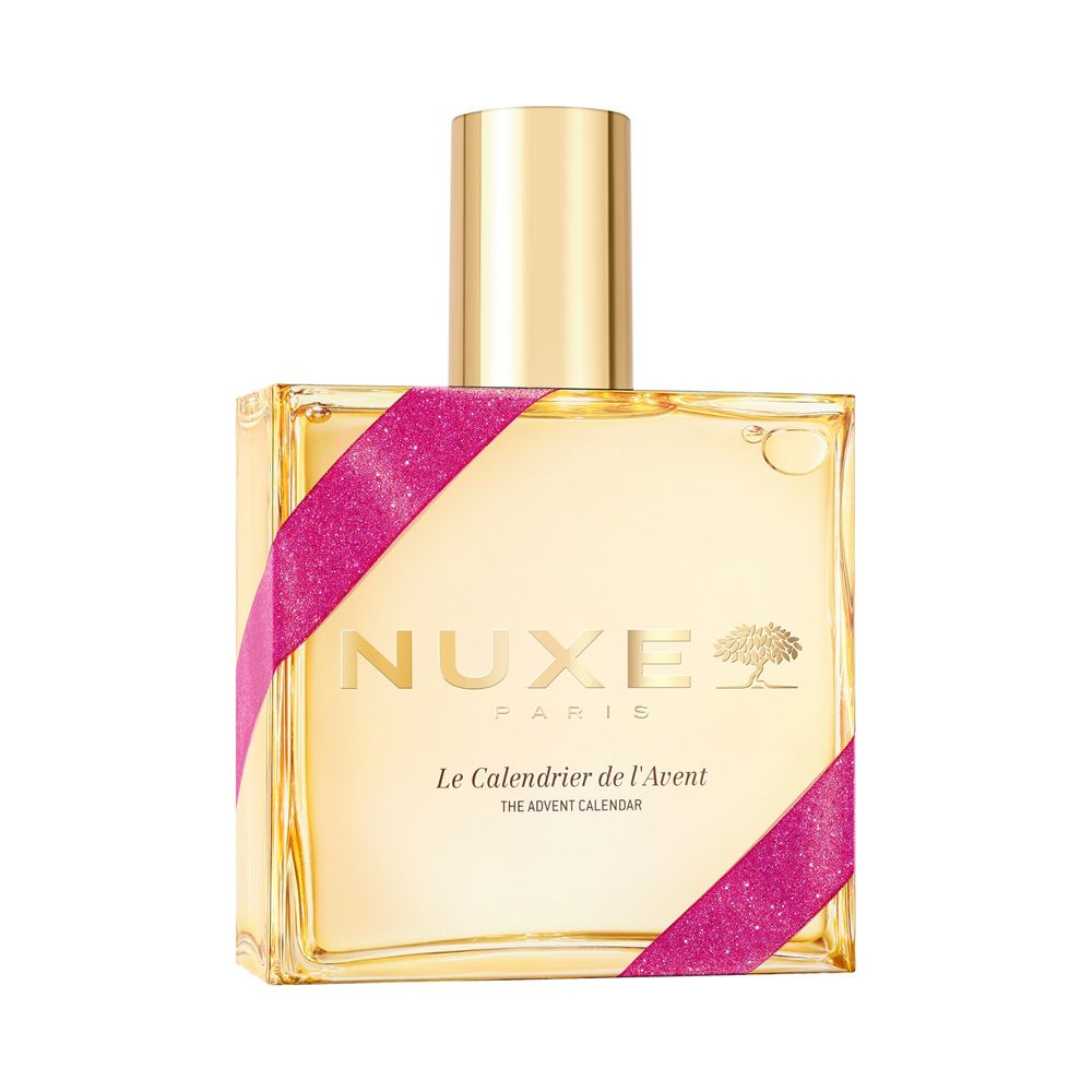 Une bouteille dorée avec logo Nuxe et ruban rose, étiquetée 'Le Calendrier de l'Avent'.