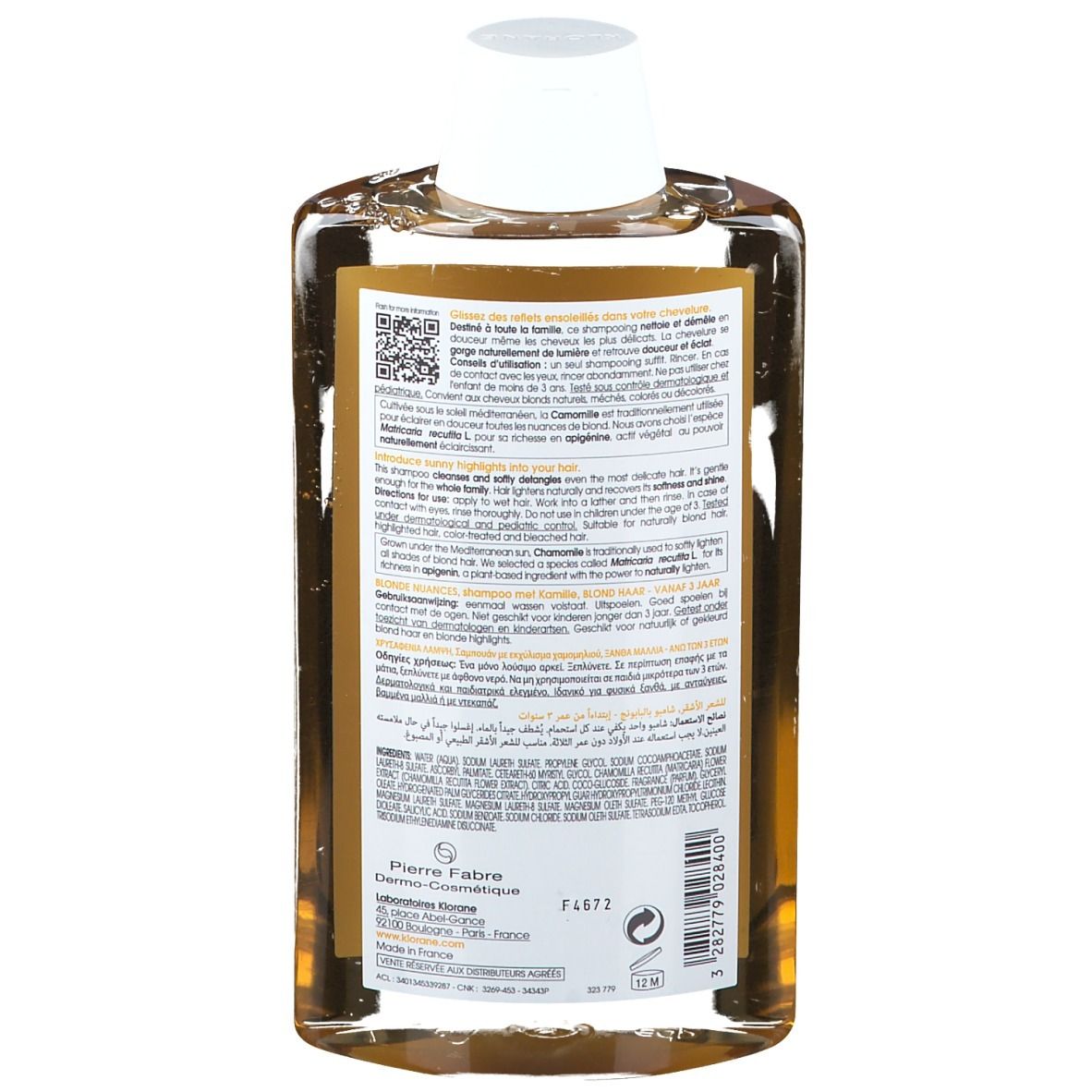 Flacon de shampooing, camomille pour cheveux colorés. Liquide transparent, bouchon blanc. Étiquette avec texte et QR code.