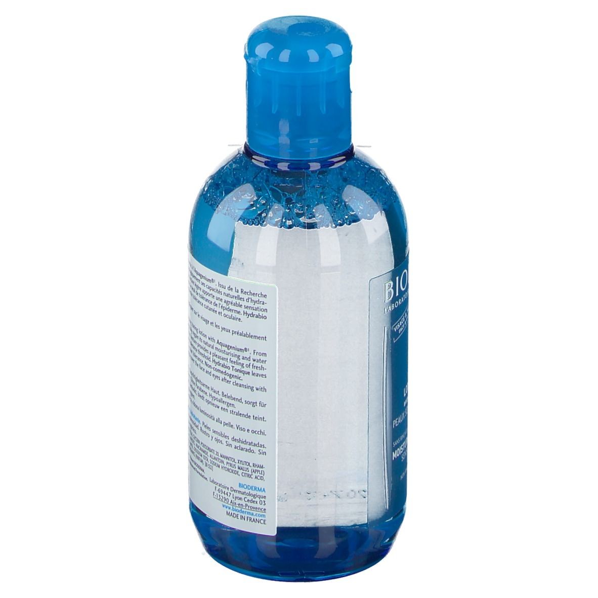 Rückansicht der blauen Flasche. Produktinformationen in mehreren Sprachen. Herstellerinformationen und Barcode.