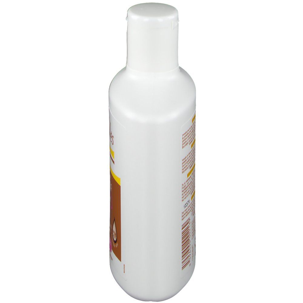 Flacon blanc, vue latérale. Inscriptions illisibles. Bouchon à clapet. Produit pour peaux sèches.