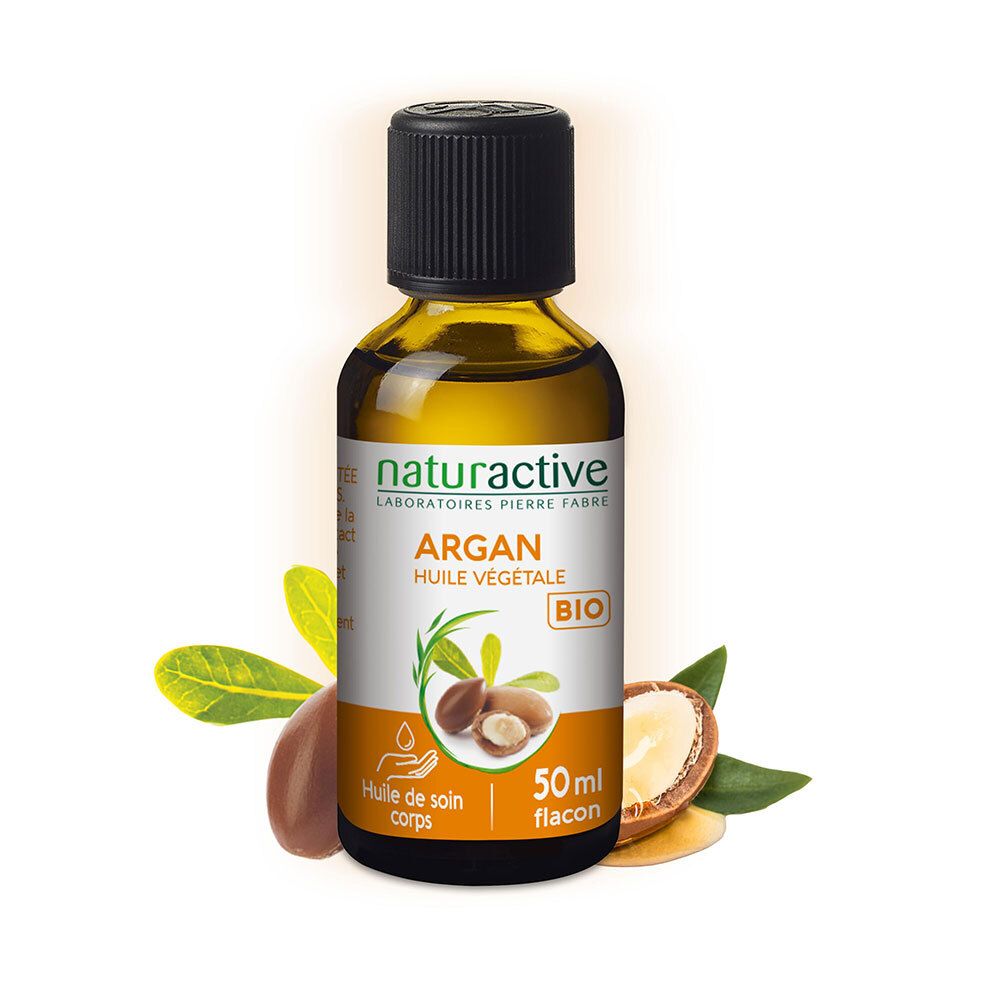 Flacon en verre brun avec bouchon noir. Étiquette avec nom du produit et label BIO. Fruits d'argan à côté.