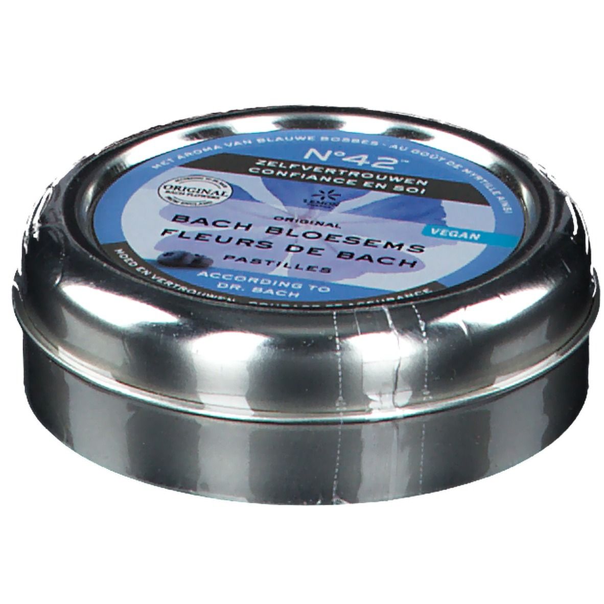 Boîte métallique ronde, légèrement inclinée. Étiquette bleue avec inscription: Fleurs du Dr. Bach Pastilles, Confiance en soi. Vegan.