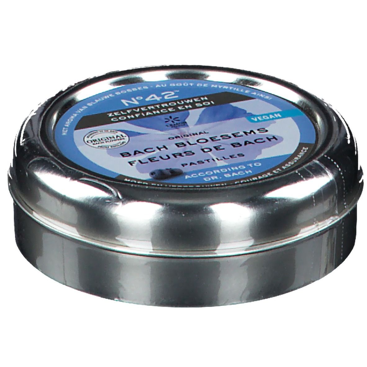 Boîte métallique ronde, légèrement inclinée. Étiquette bleue avec inscription: Fleurs du Dr. Bach Pastilles, Confiance en soi. Vegan.