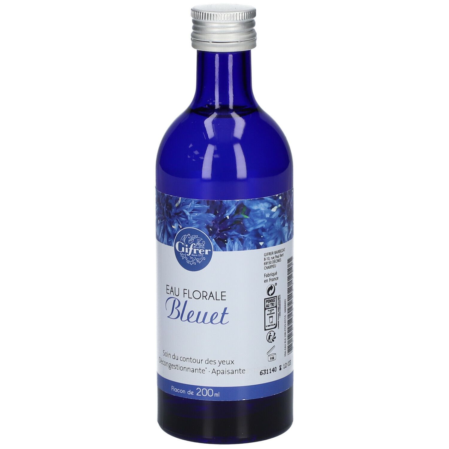 Flacon bleu en verre, bouchon argenté. Étiquette avec nom du produit et motif floral. Texte: Eau Florale Bleuet. 200ml.
