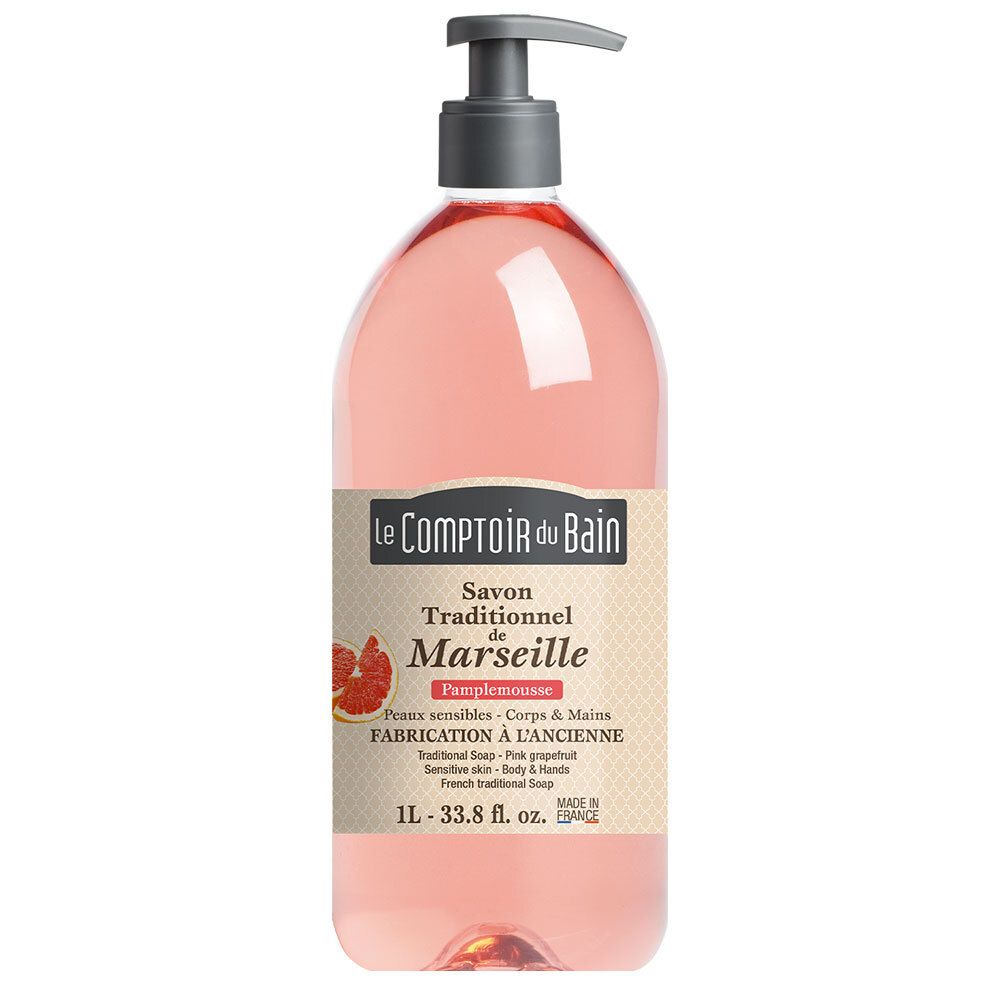Rosa Grapefruit-Seife in einer transparenten Flasche mit Pumpe. Etikett mit Produktinformationen und Logo.
