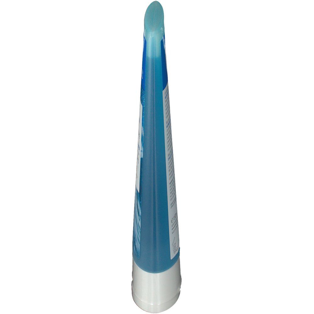 Schlanke, blaue Tube mit weißem Boden. Oben abgerundet. Vorderseite mit Wellenmuster.