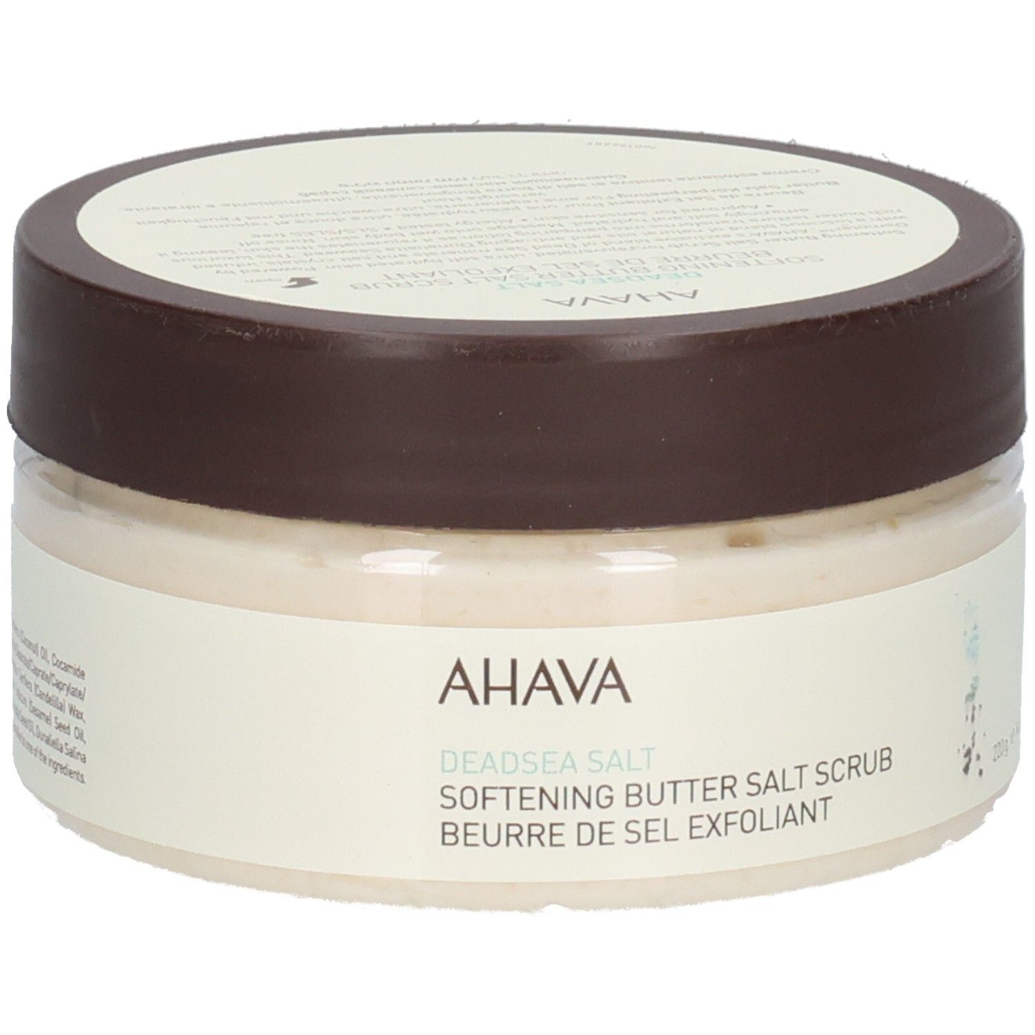 Ahava-Produkt. Rundes, transparentes Gefäß mit braunem Deckel. Aufschrift: AHAVA, Deadsea Salt, Softening Butter Salt Scrub, Beurre de Sel Exfoliant.