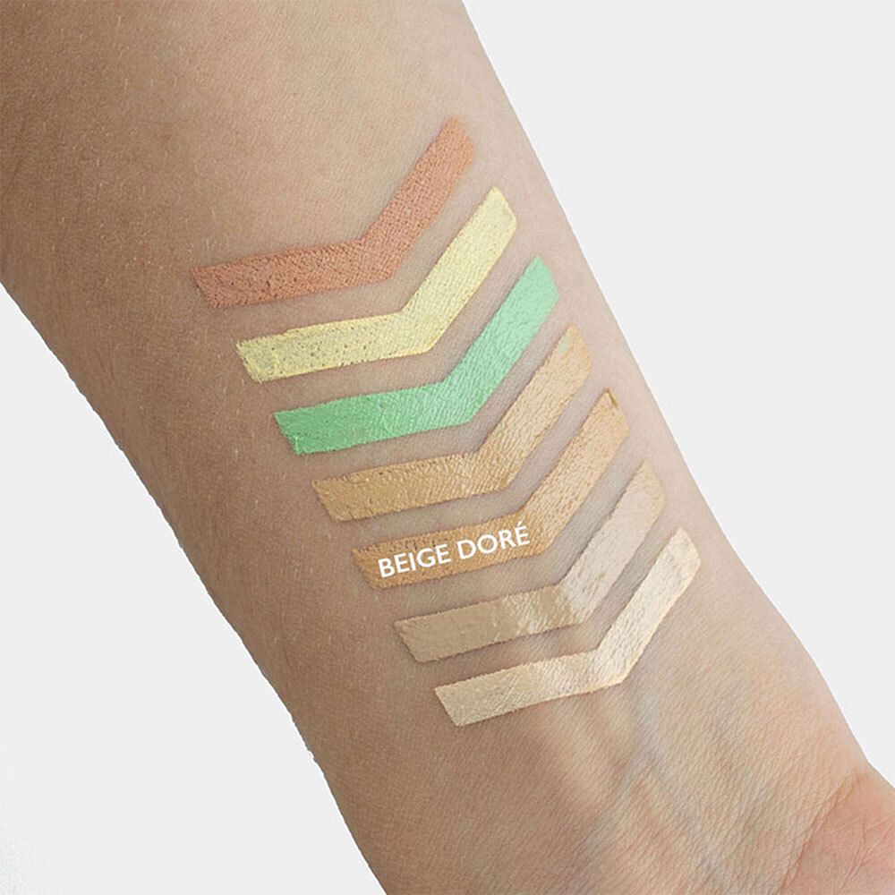 Bras avec échantillons de couleurs de correcteurs. Flèches de couleurs variées. Texte : BEIGE DORÉ.