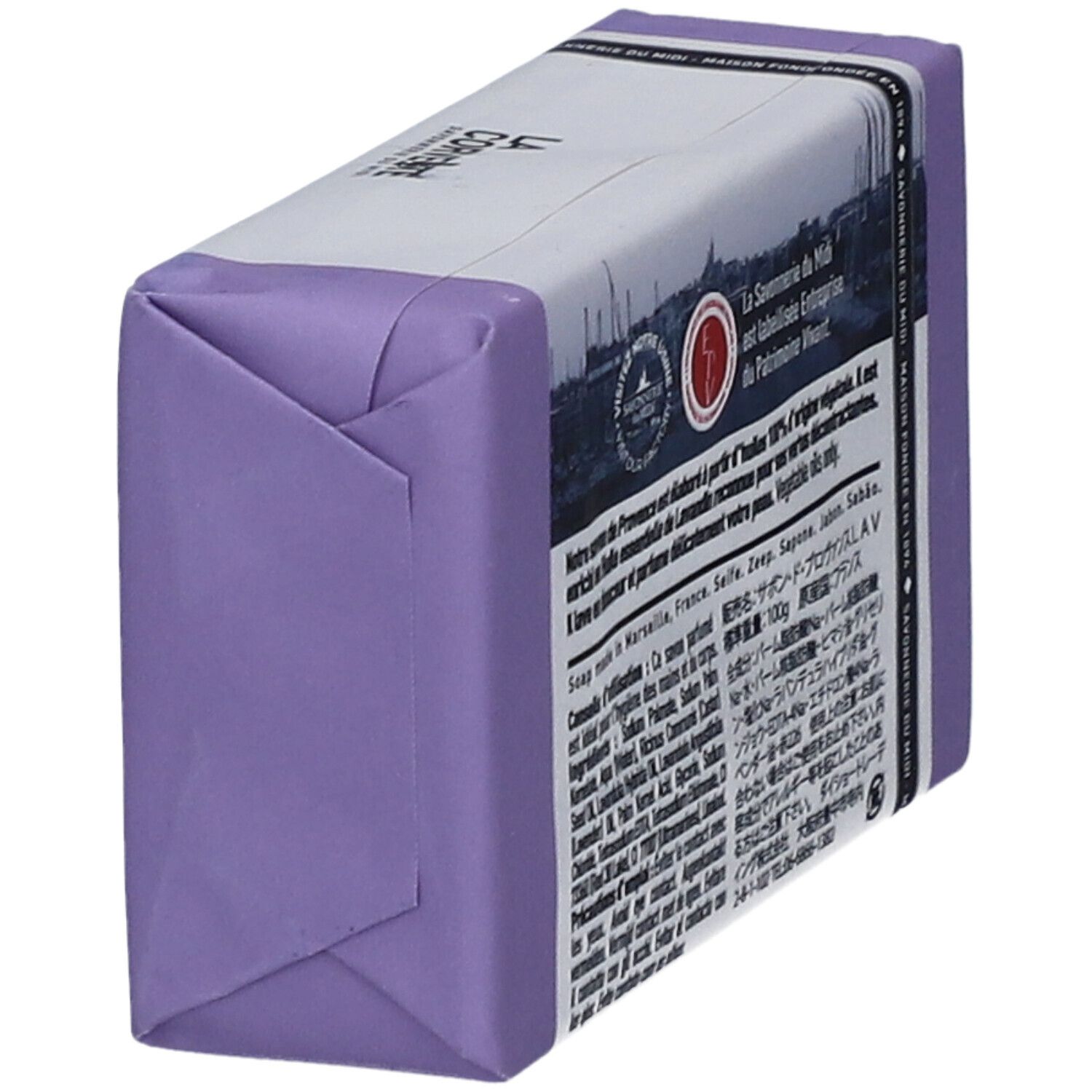 Savon emballé en violet. Texte multilingue sur l'emballage.