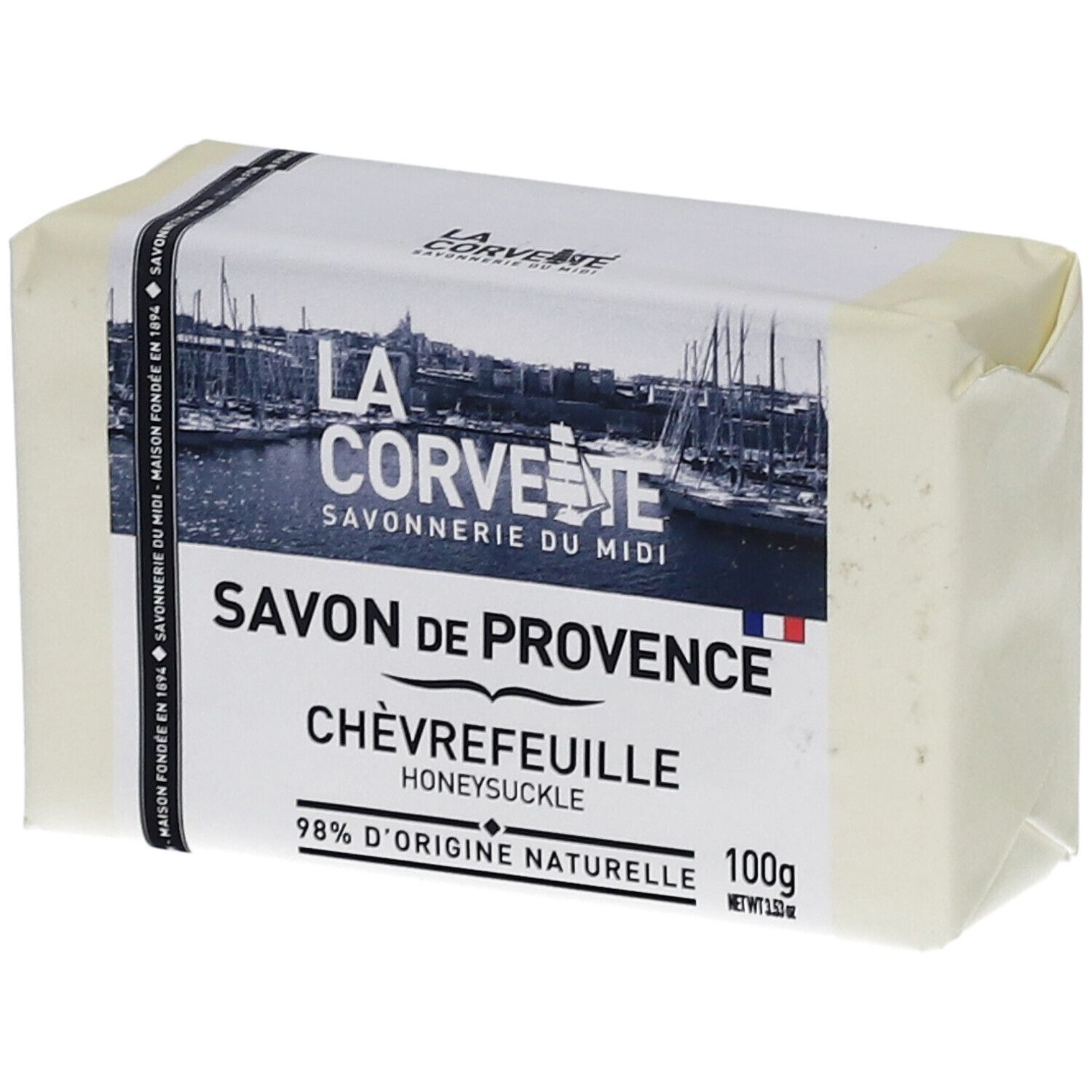 Savon emballé. Inscriptions: Savon de Provence Chèvrefeuille, 98% d'origine naturelle. Logo et nom de marque visibles.