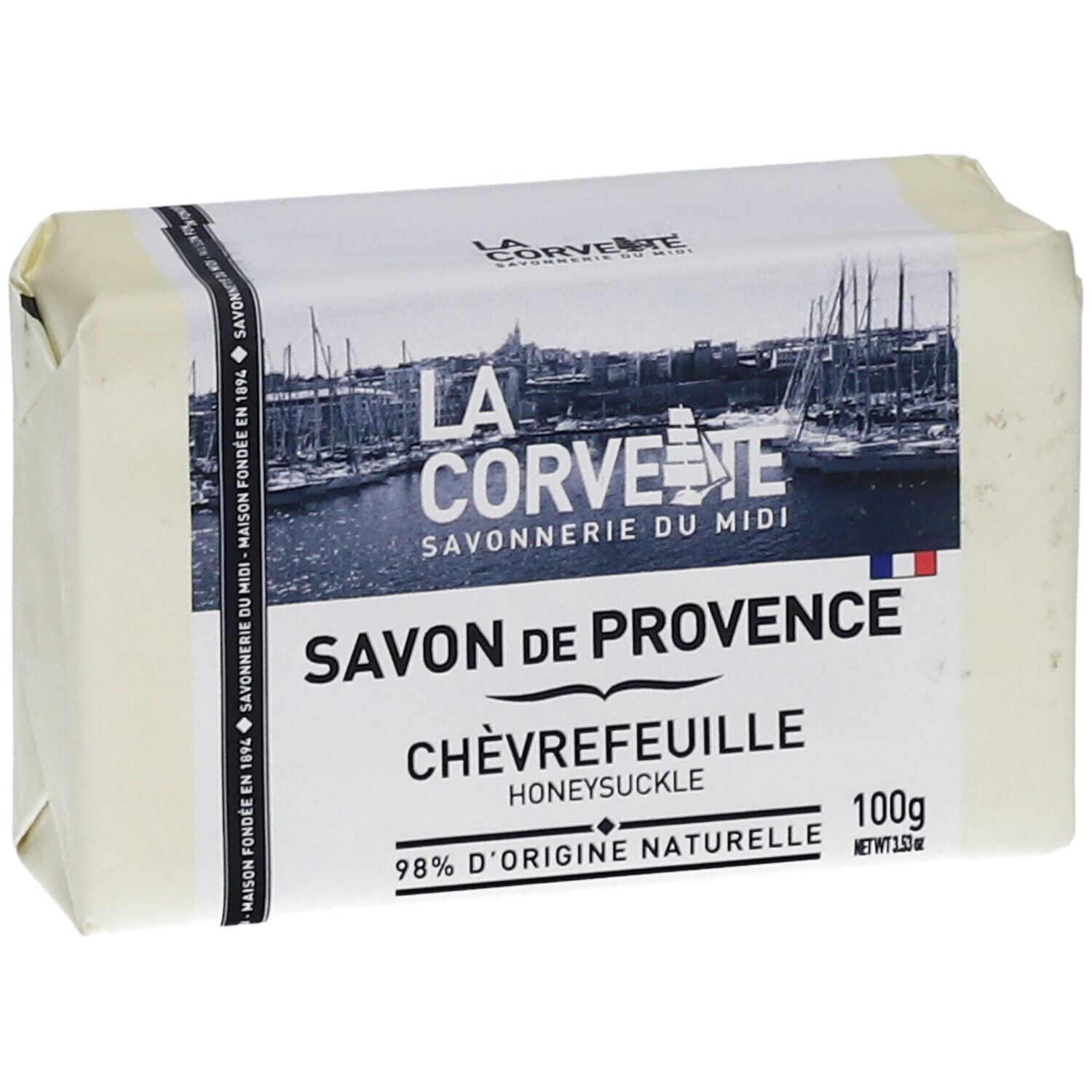 Savon emballé. Inscriptions: Savon de Provence Chèvrefeuille, 98% d'origine naturelle. Logo et nom de marque.