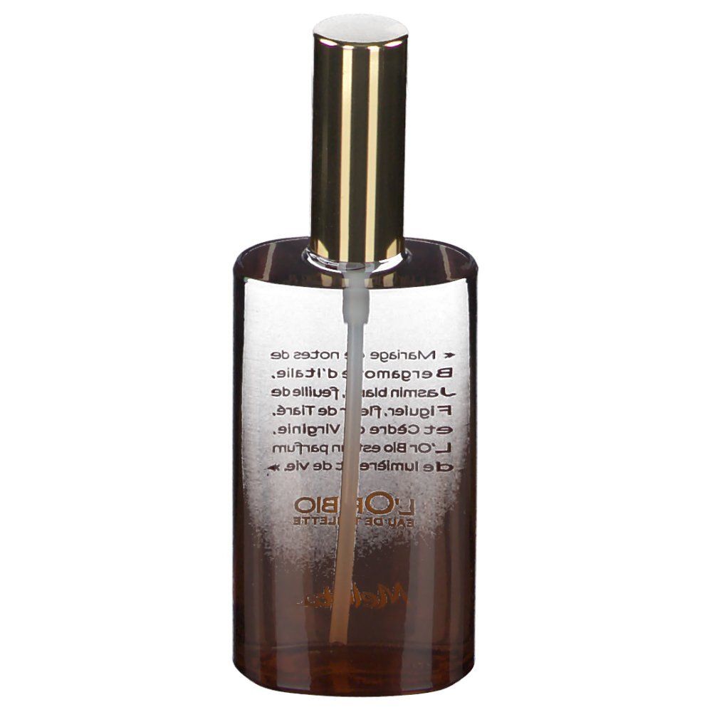 Flacon de parfum avec bouchon doré. Inscription: L'Or Bio Eau de Toilette. Texte avec ingrédients.