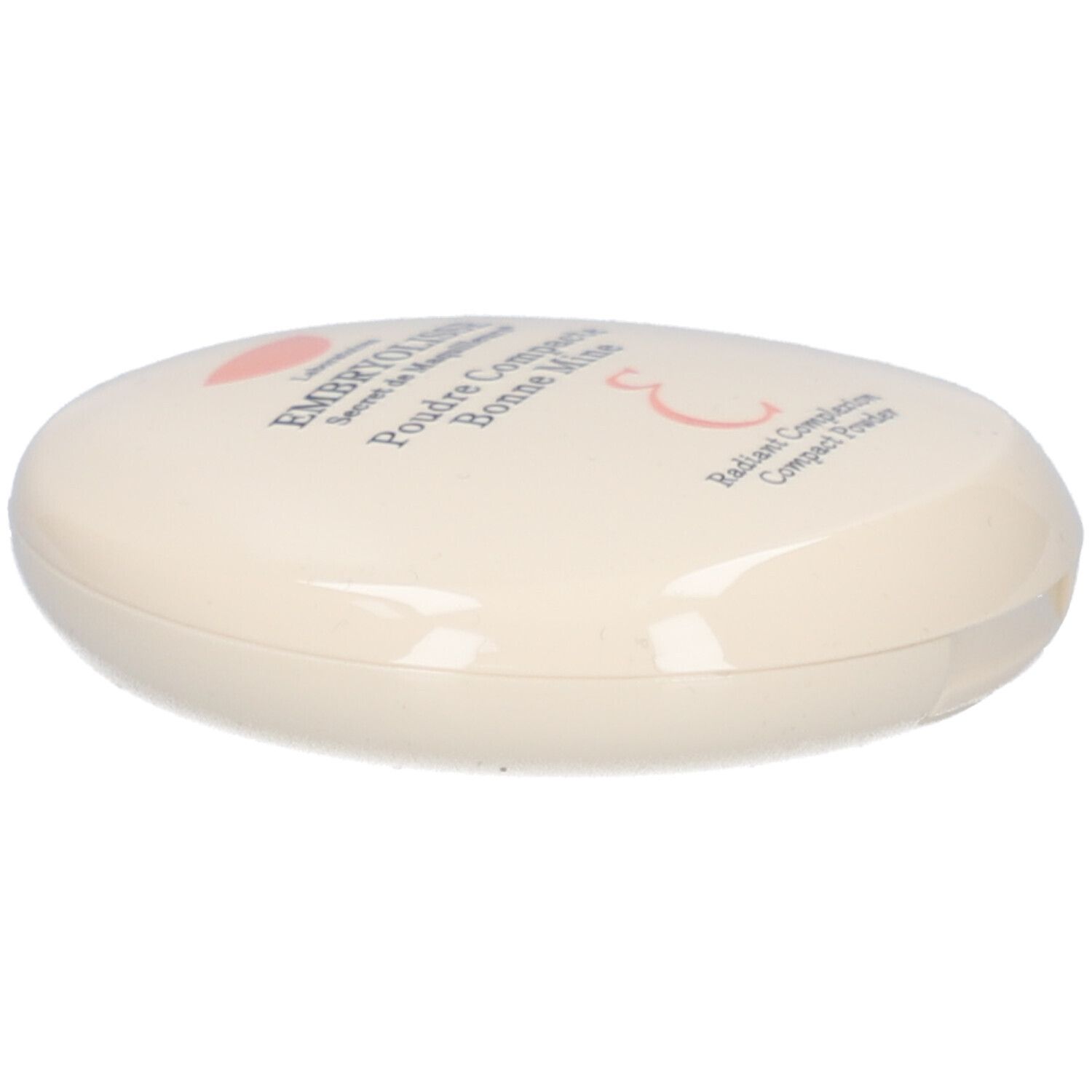 Boîtier de poudre compacte ovale, crème. Inscription: EMBRYOLISSE, Poudre Compacte Bonne Mine. Logo rose.