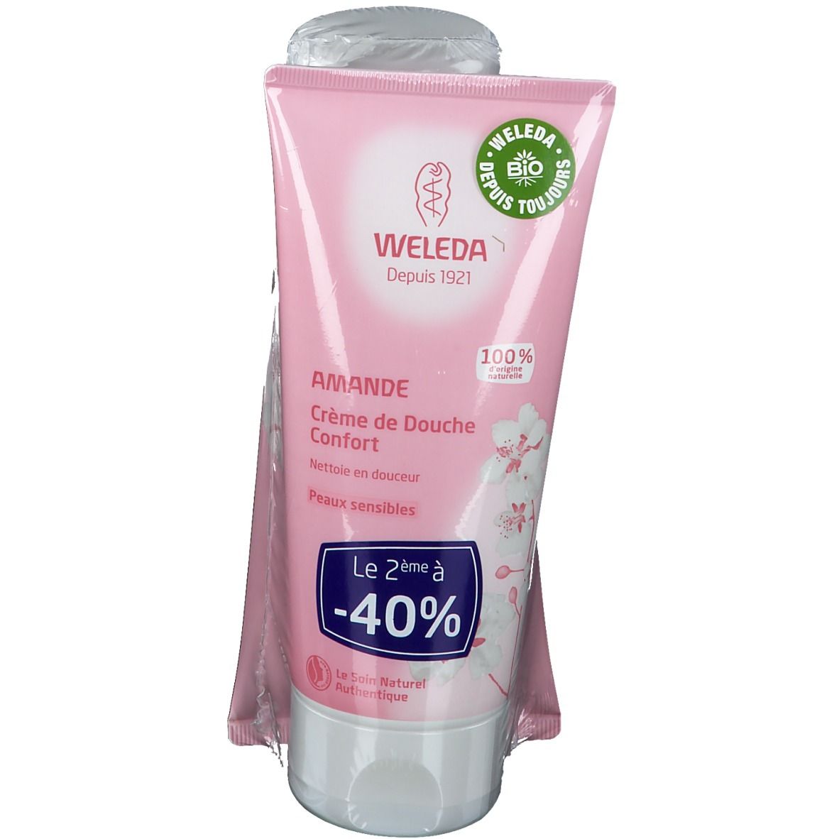 Tube rose avec bouchon blanc. Inscription: WELEDA, AMANDE, Crème de Douche Confort. Label bio. -40% de réduction.