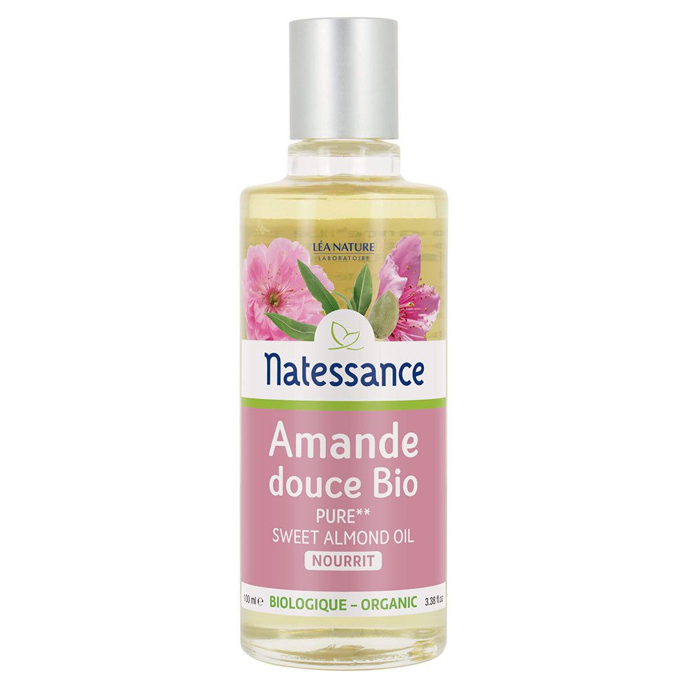 Flacon en verre transparent avec bouchon argenté. Étiquette: Natessance, Amande douce Bio, Sweet Almond Oil. Contient une image florale.