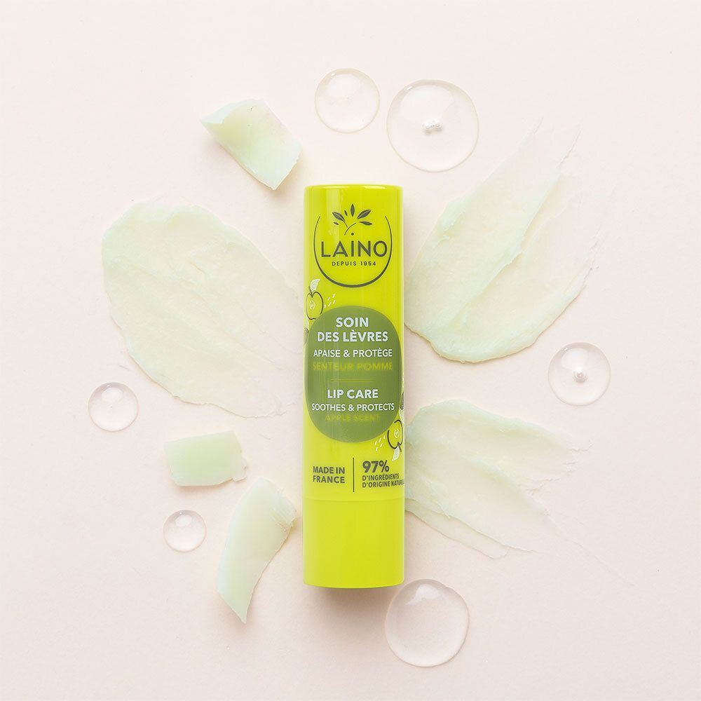 Grüner Lippenpflegestift mit grünen Cremespritzern und Wassertropfen. Aufschrift: LAINO, SOIN DES LÈVRES, LIP CARE, 97%.