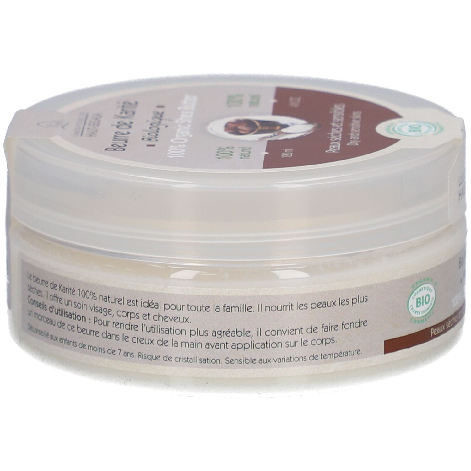 Pot cylindrique avec couvercle. Inscription: Beurre de Karité Biologique, 100% Organic Shea Butter. Label bio. Texte au dos.