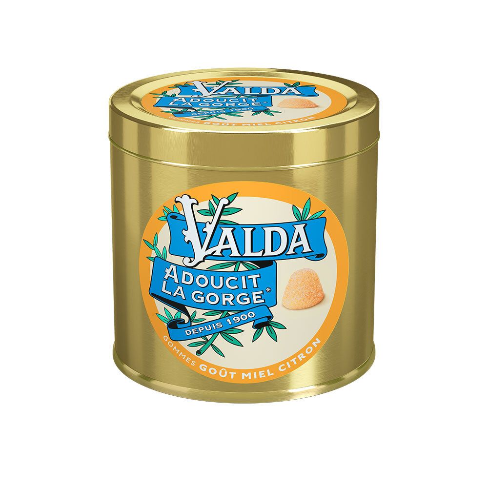 Goldfarbene Dose mit blauem Etikett. Aufschrift: VALDA, Adoucit la Gorge, Depuis 1900. Abbildung eines Bonbons.
