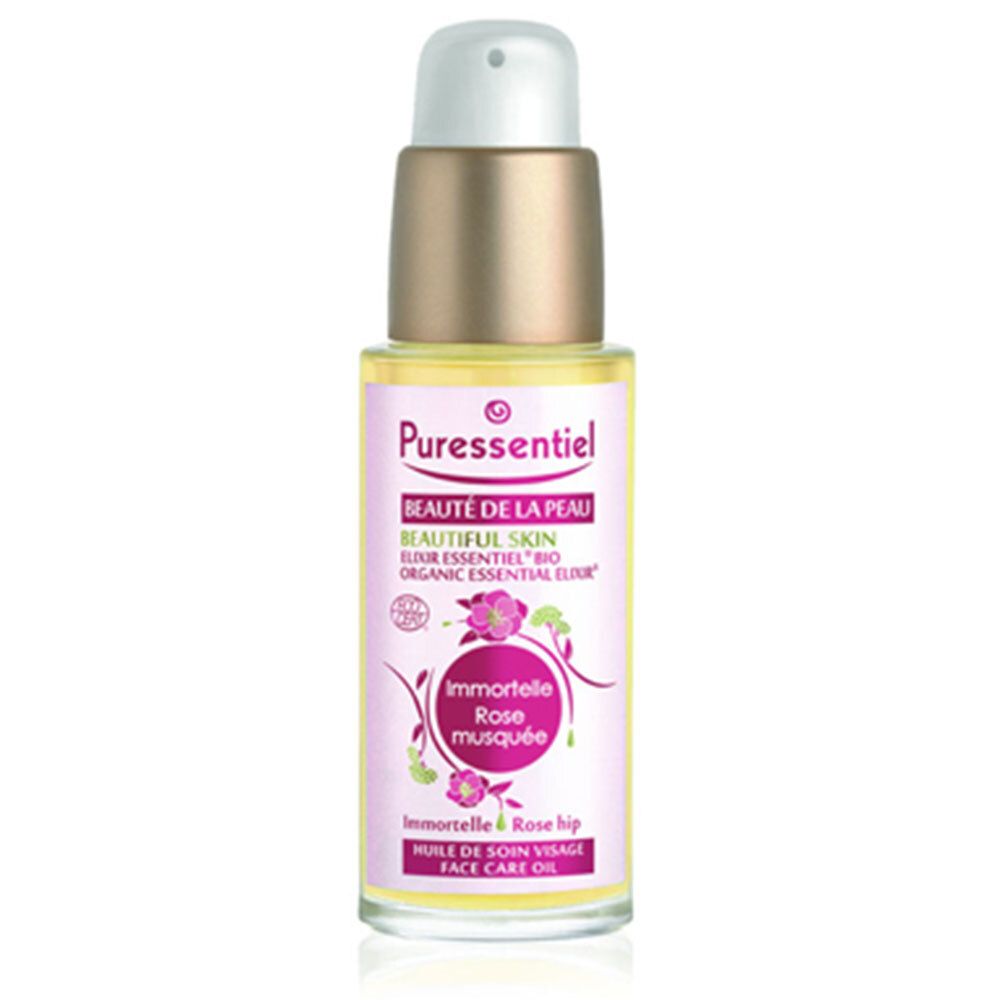 Flacon d'huile pour le visage avec bouchon doré. Étiquette avec nom du produit et motif floral.