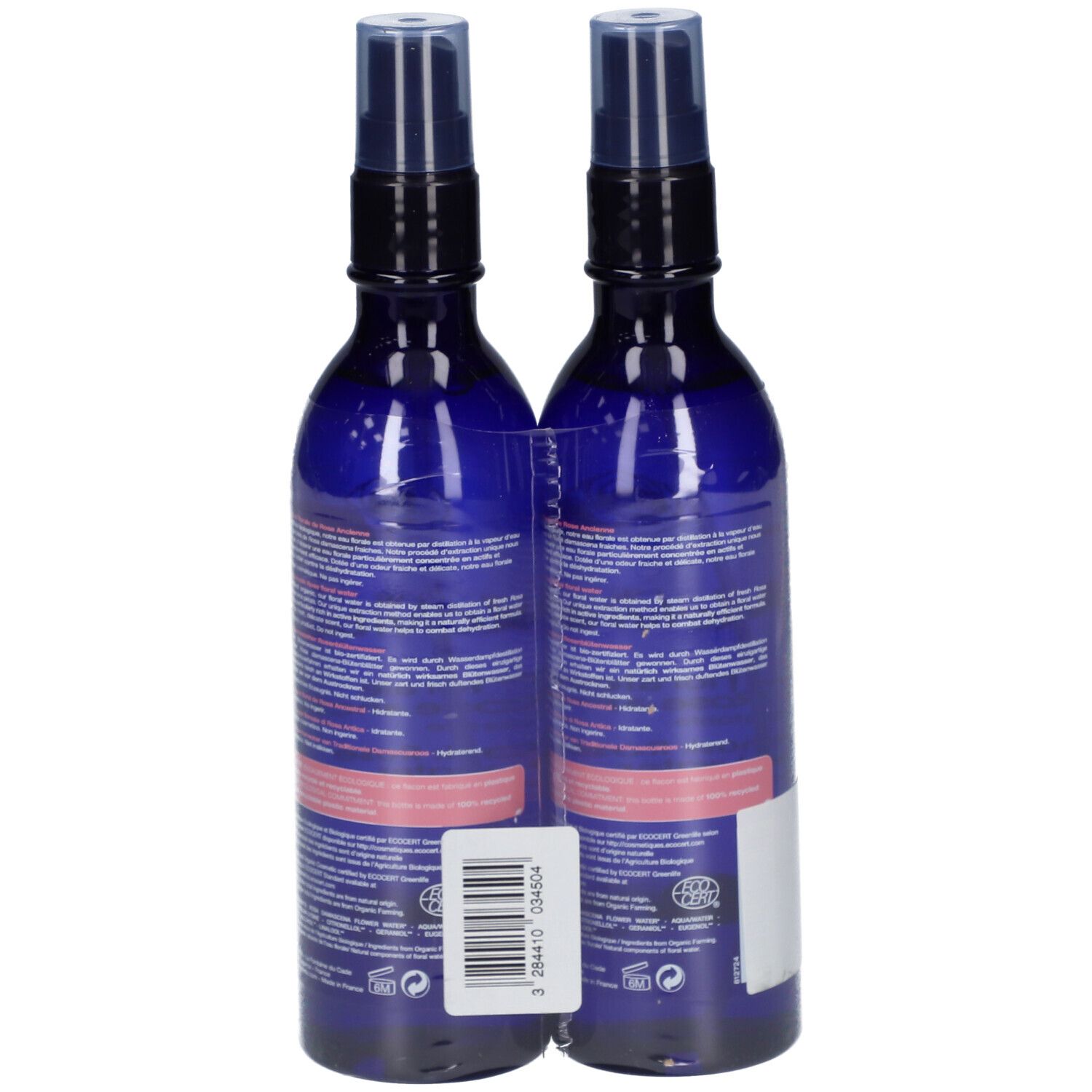 Deux flacons bleus, vue arrière. Étiquettes avec texte. Emballés dans du film transparent. Code-barres et label bio.