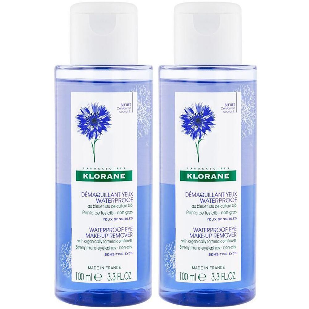 Zwei Klorane wasserfeste Augen-Makeup-Entferner Flaschen. Blaue Flüssigkeit, weißer Deckel. Kornblumen-Motiv.