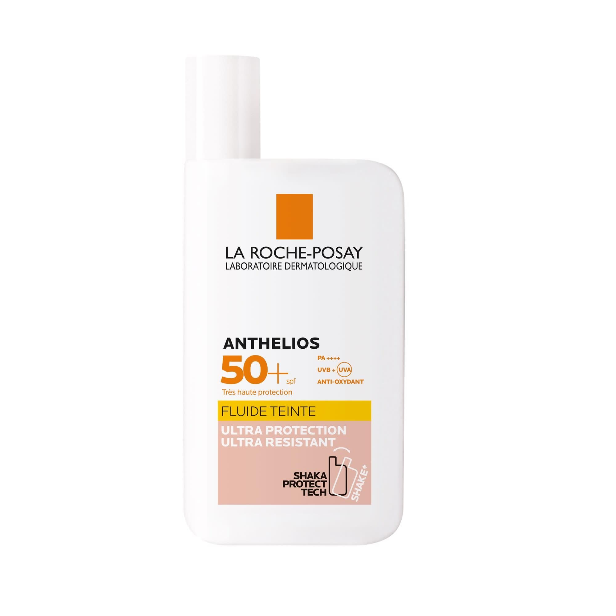 Sonnencreme-Flüssigkeit mit SPF 50+. Weiße Flasche mit orangefarbenem Akzent. Text: Anthelios, Fluide Teinte.