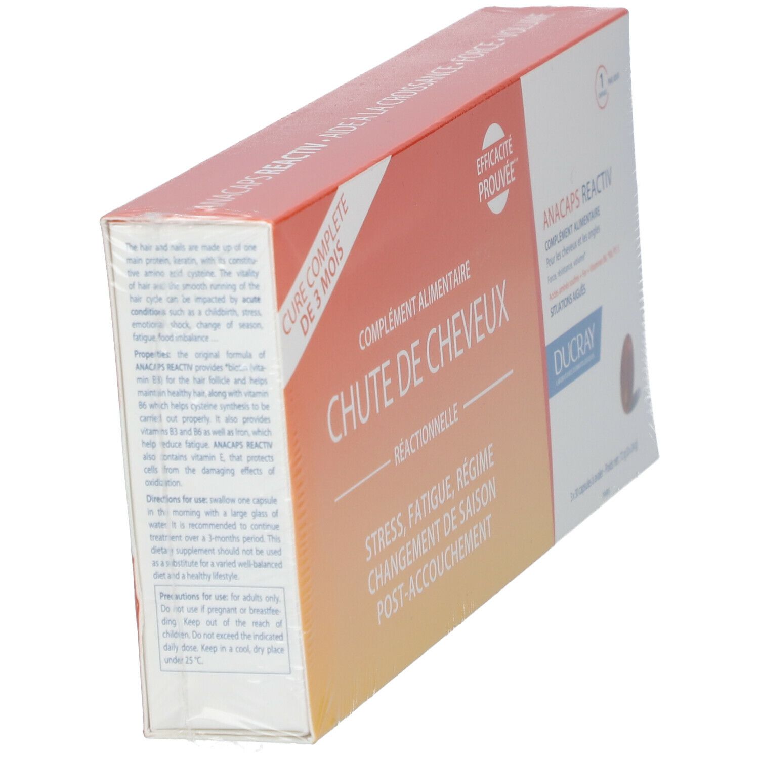 Schräg gestellte Verpackung. Text: CHUTE DE CHEVEUX, ANACAPS REACTIV, DUCRAY. Orange-weißes Design. Kapsel-Abbildung. Teilweise transparente Folie.